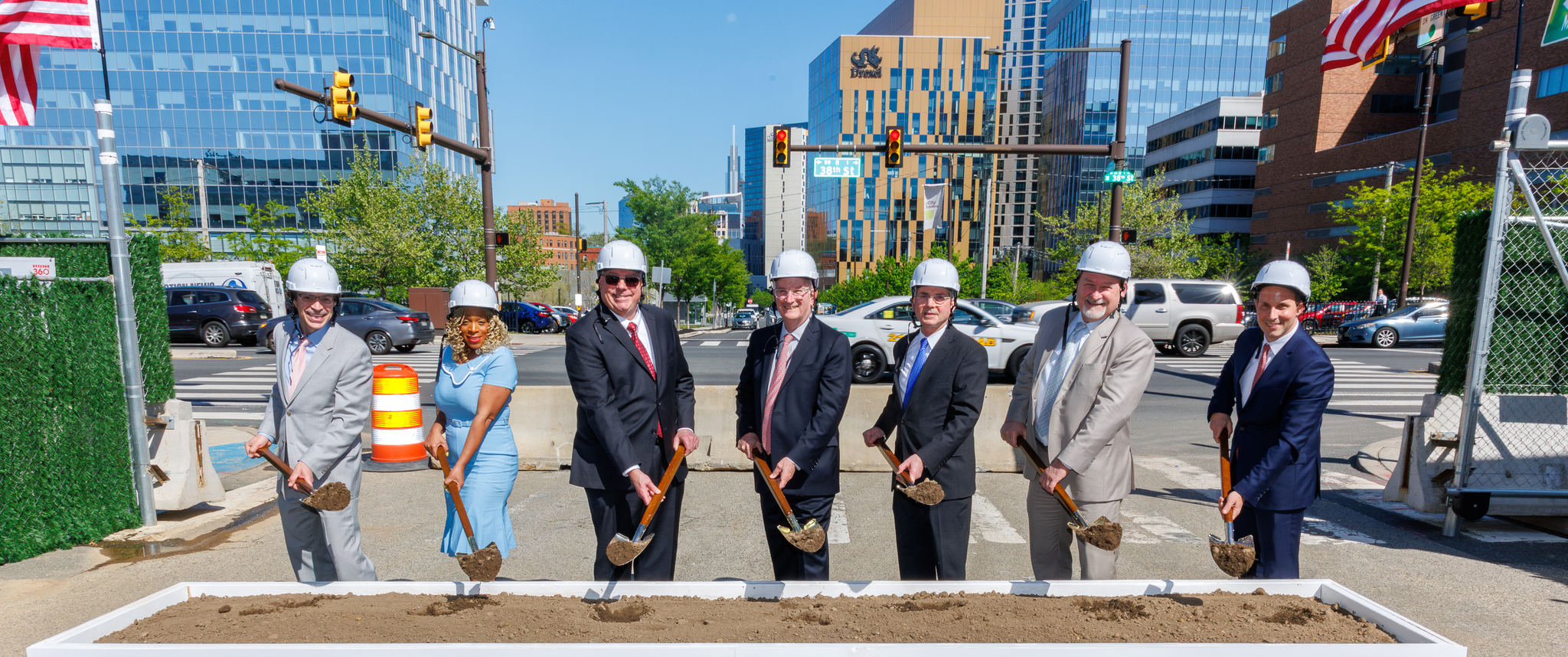 Leaders and public officials hold ceremonial shovels for the groundbreaking of the Roberts Proton Therapy Center at Penn Presbyterian