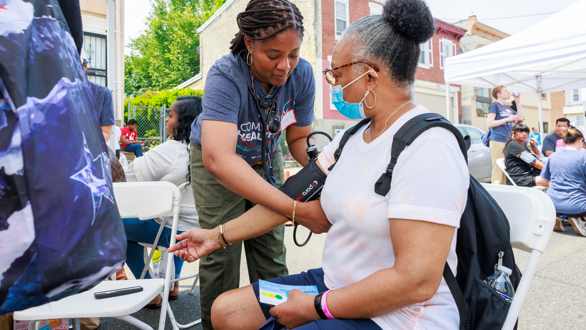 Nurse takes woman's blood pressure at Community Health Fair event