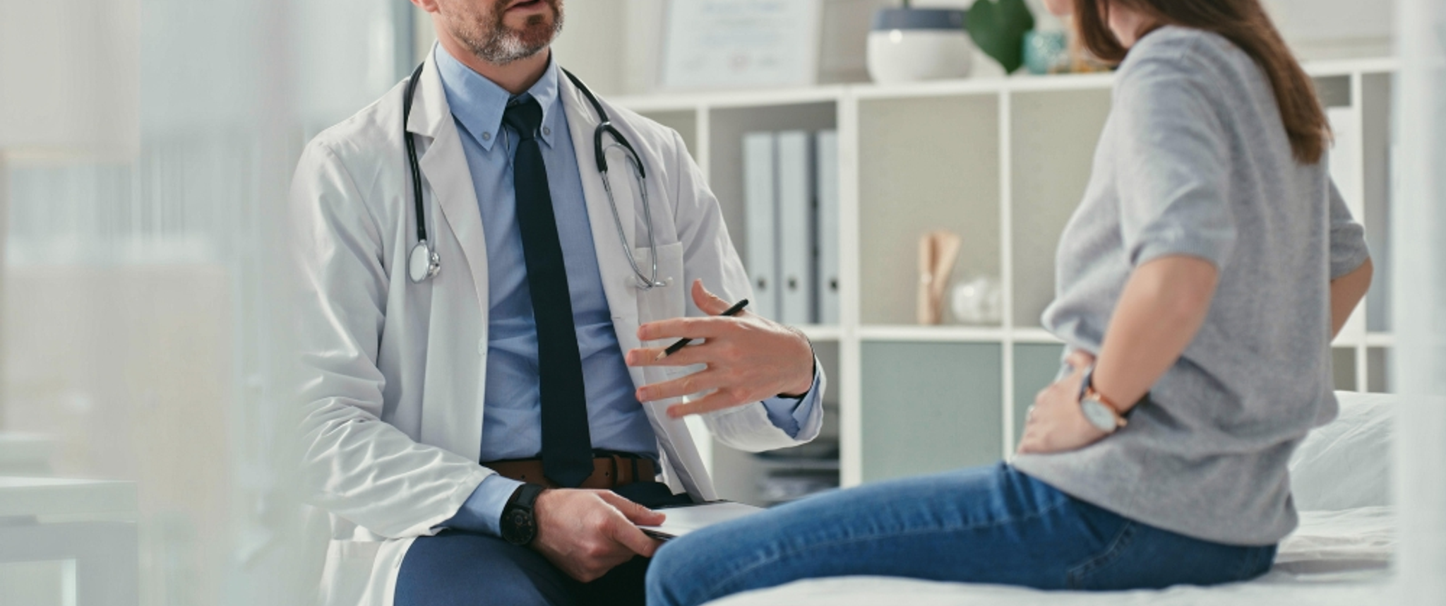 A physician is shown counseling a young patient
