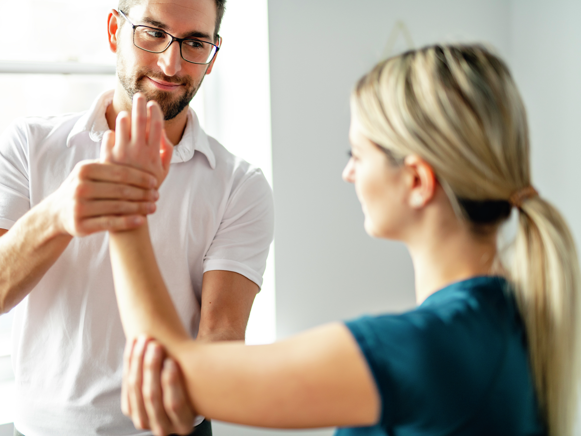 Doctor helping patient rehab hand wrist injury