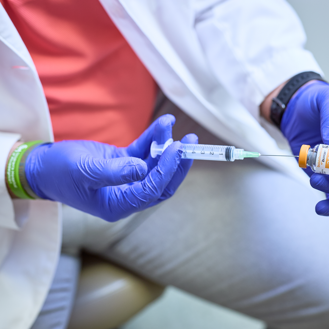 Doctor filling a syringe with Botox