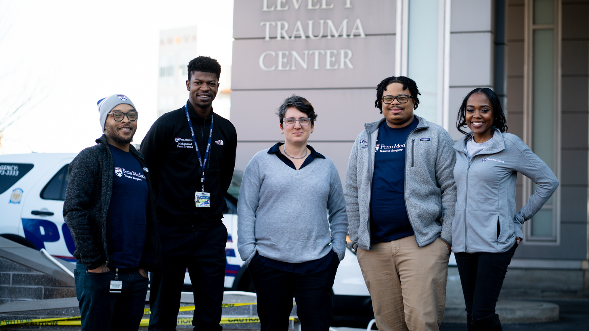 Five members of the Penn Trauma Violence Recovery Program standing outside of the Penn Presbyterian Medical Center Level 1 Trauma Center
