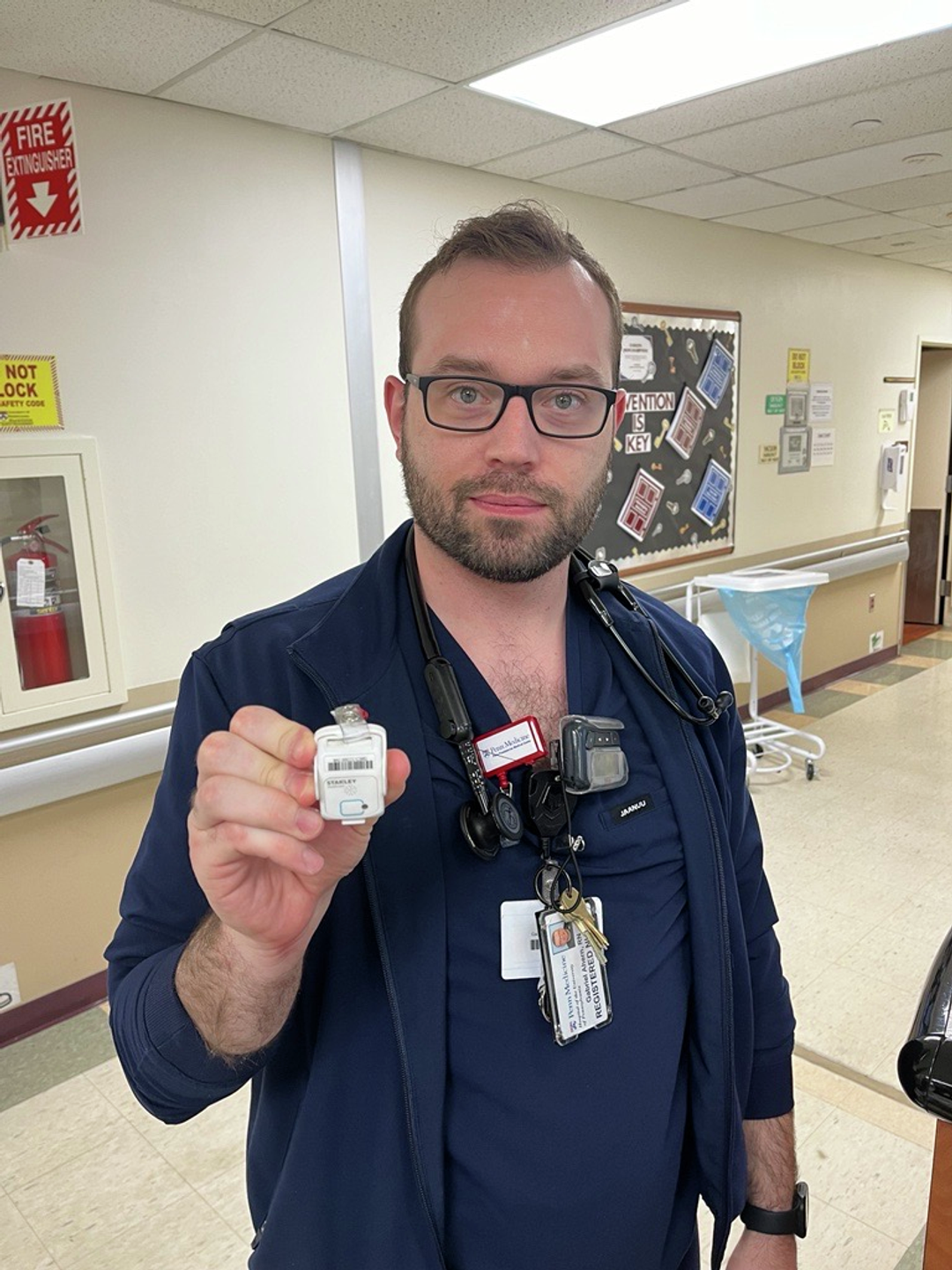 A nurse holds a duress badge