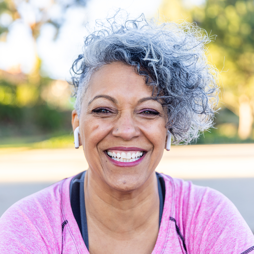 A mature black woman enjoying outdoors.