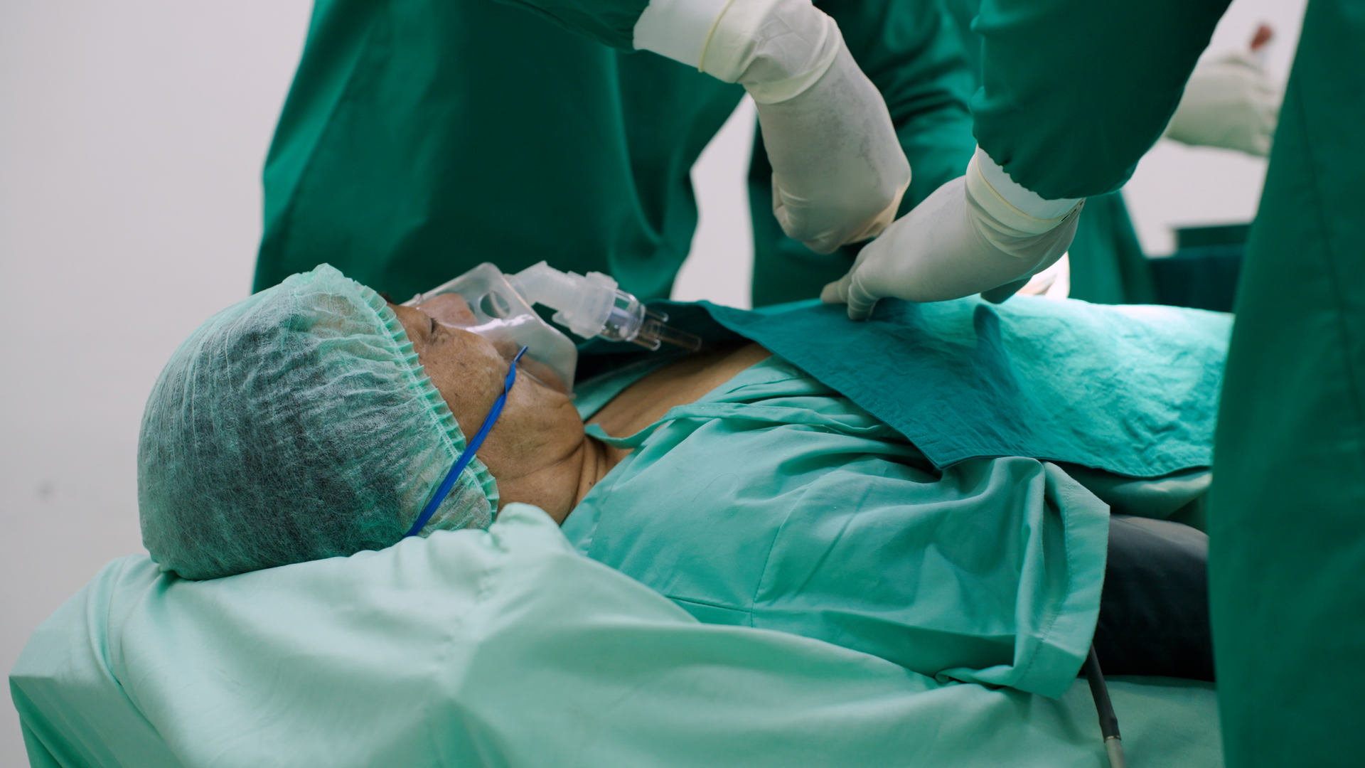 Senior man undergoing heart surgery in the operating room