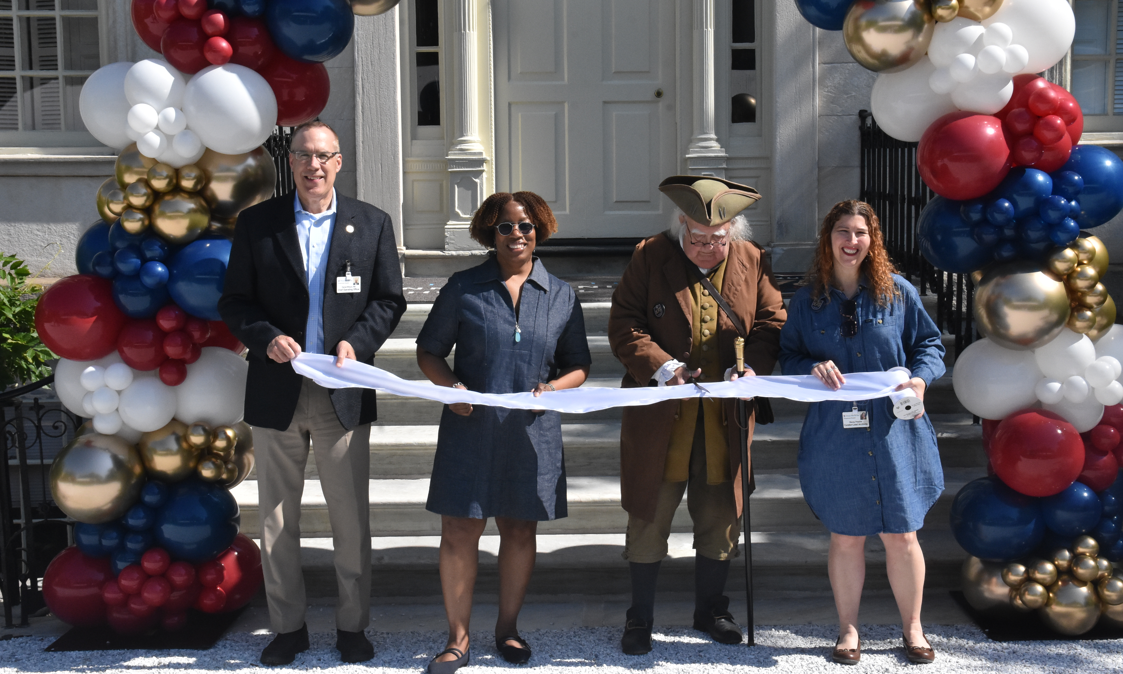 Dan Wilson, Alicia Gresham, a Benjamin Franklin reenactor, and Stacey Peeples at a ribbon cutting ceremony for the Pennsylvania Hospital Museum opening