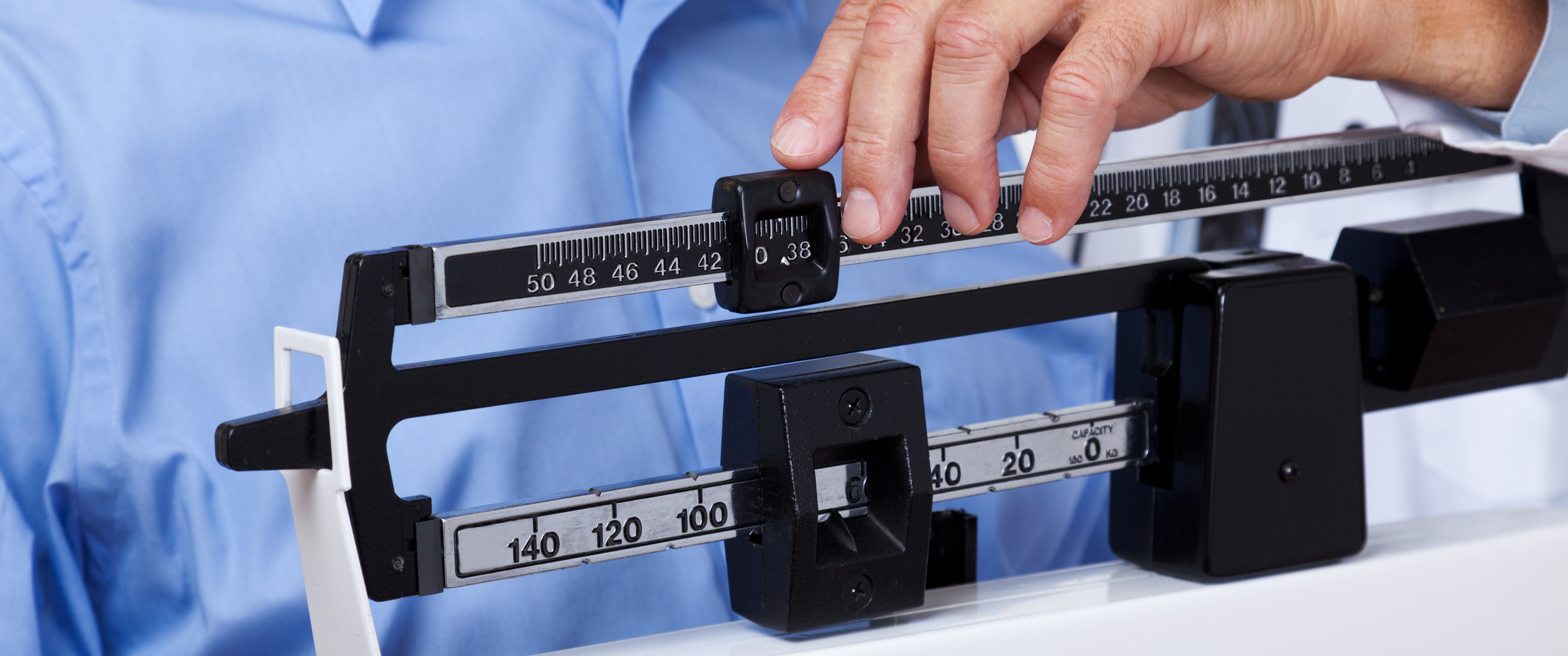 Doctor weighing a male patient