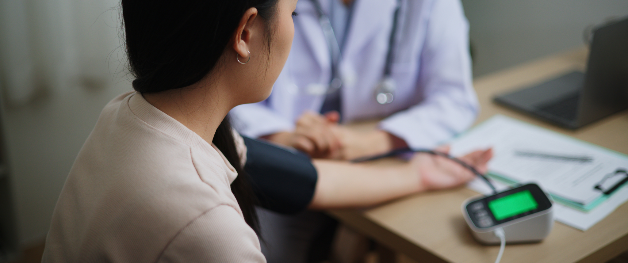 A doctor  checks a patient's blood pressure