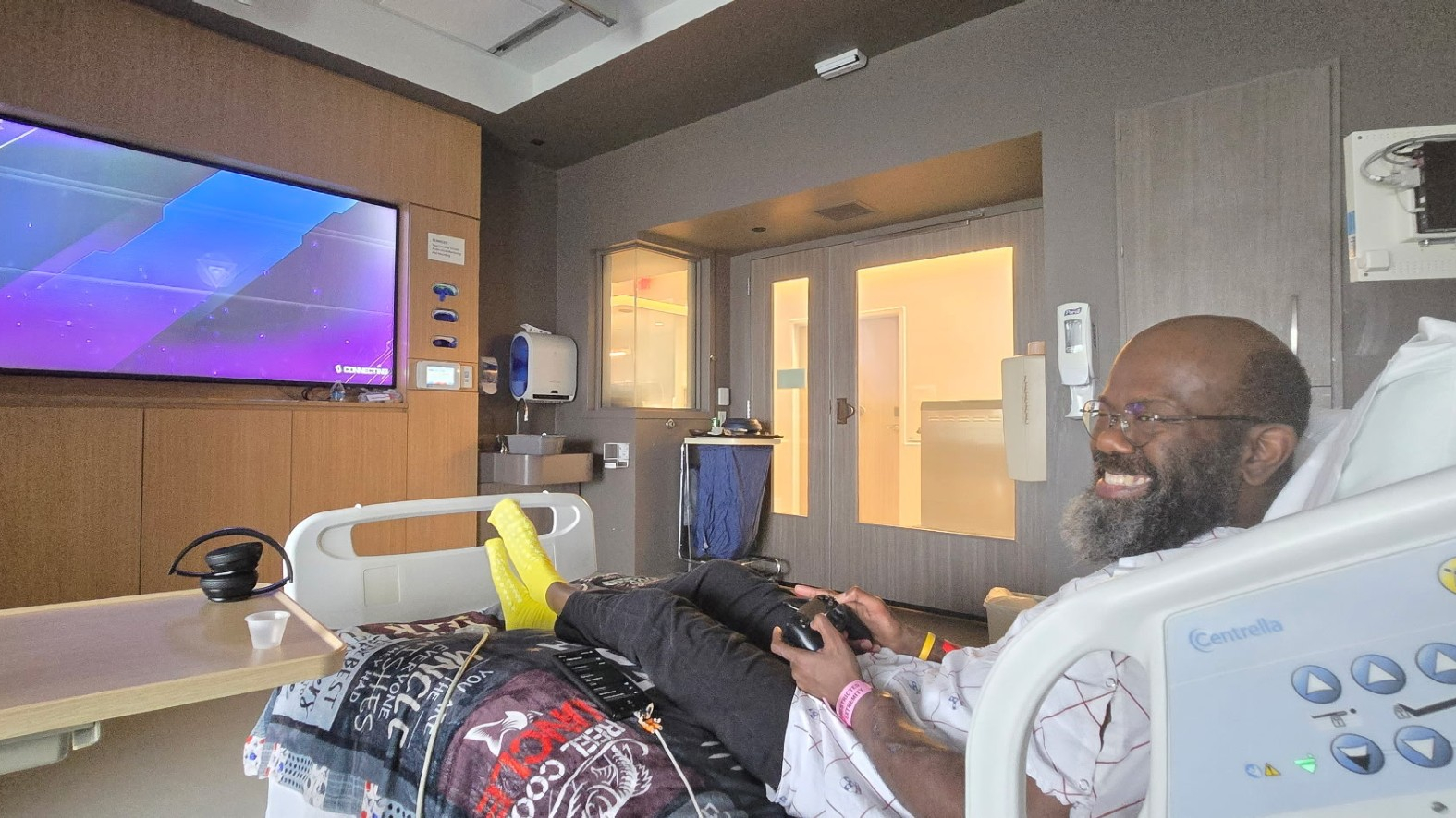 Andrew Boyd sitting in hospital bed