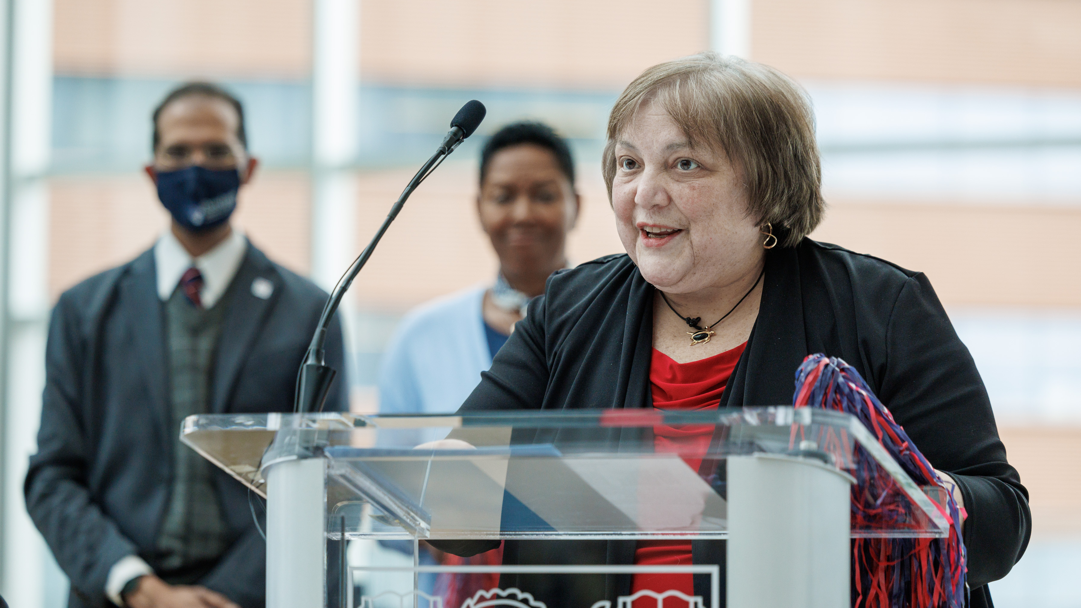 Dean Suzanne Rose, MD, MSEd, speaking at a podium.