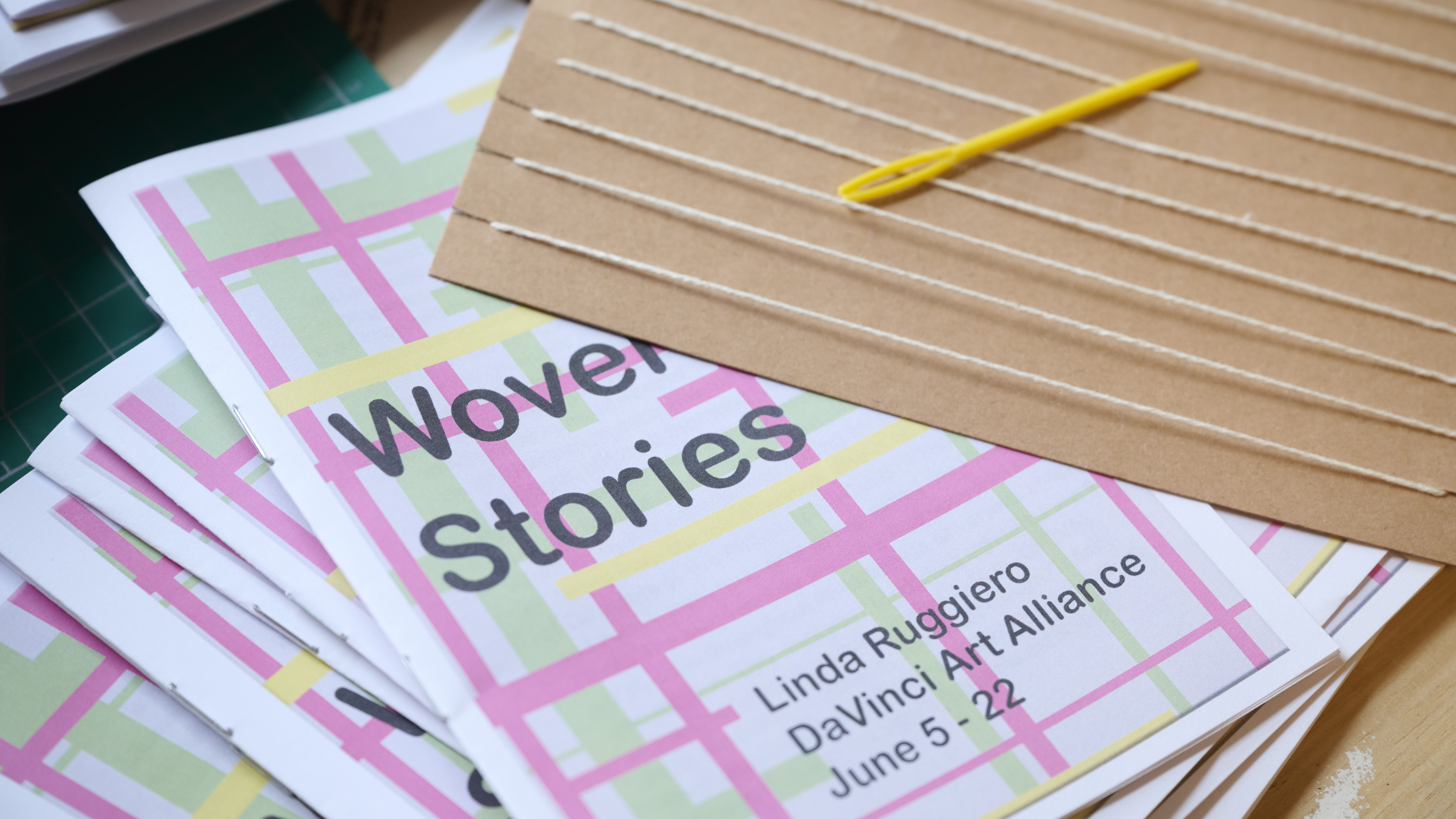 A stack of programs that nurse Linda Ruggiero made for her first solo show, which included hand-made paper looms