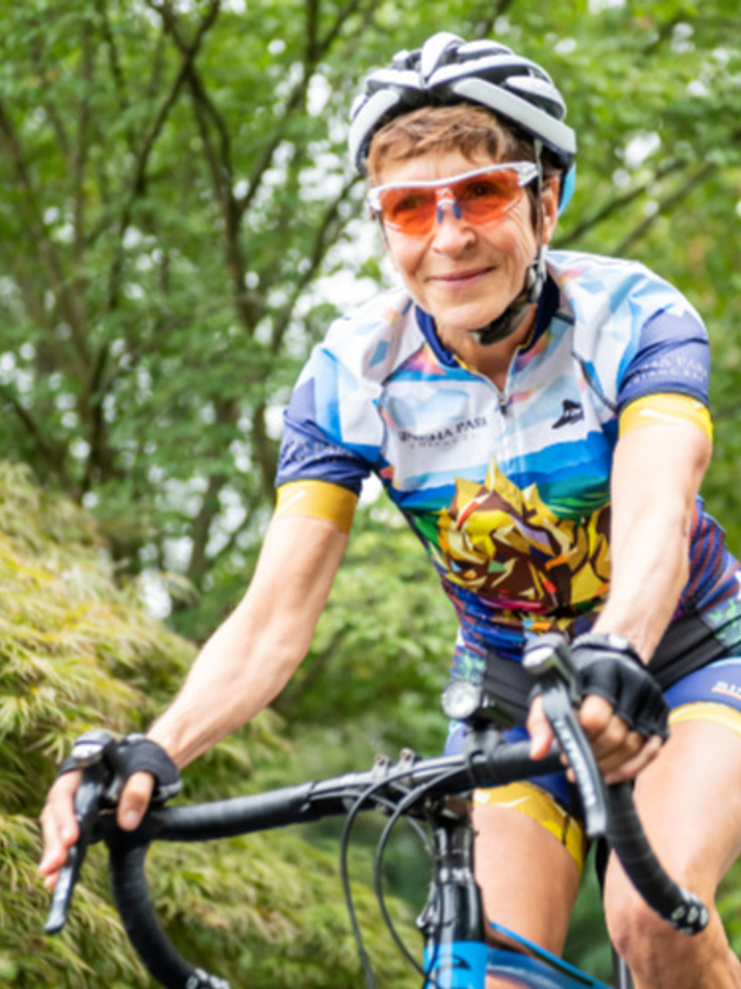 Woman in blue outfit riding a bike