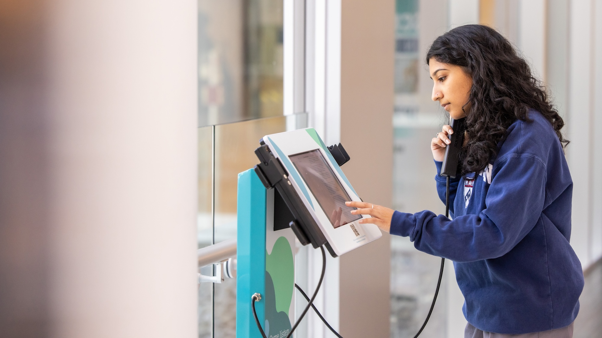 A person interacting with a Penn Medicine Listening Lab device