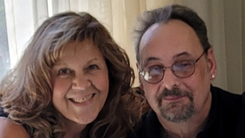 Steve and Michelle Lengle sitting next to each other at a table, smiling