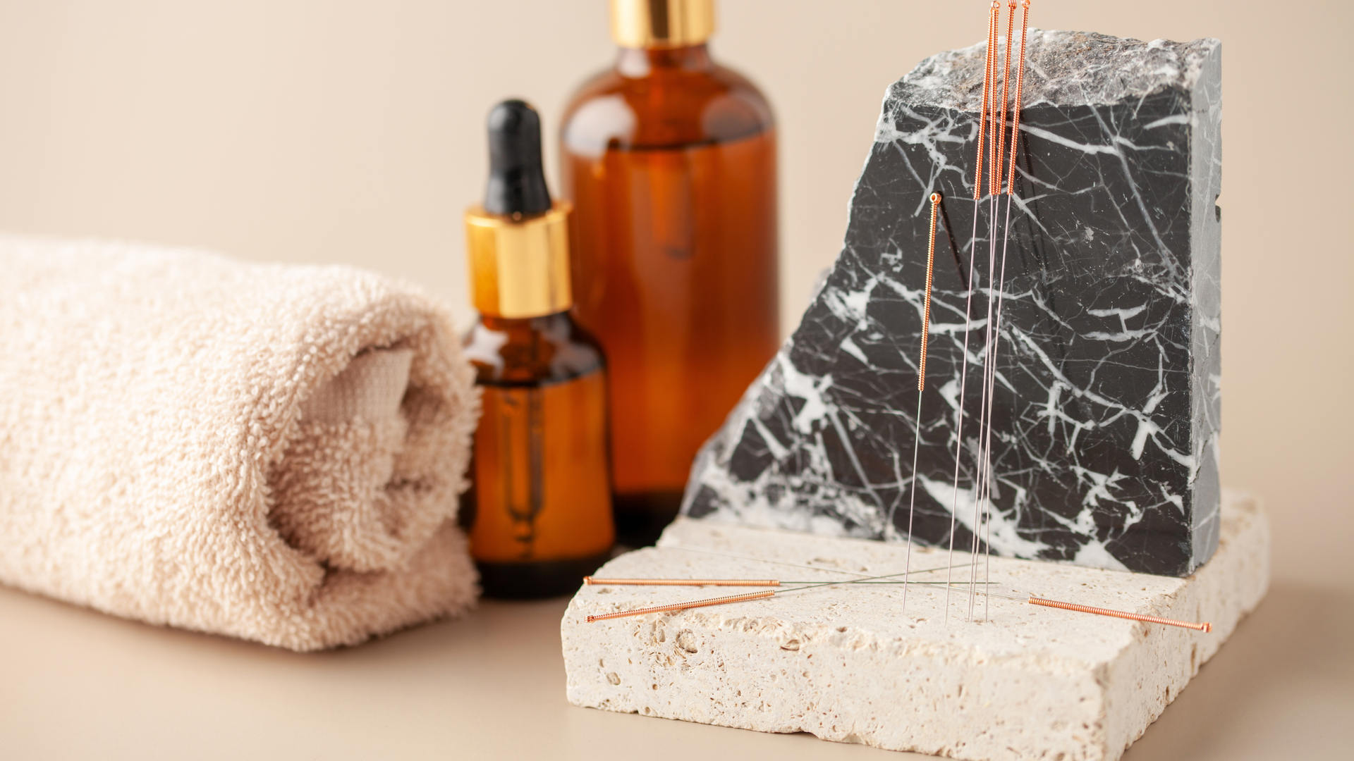Photo of acupuncture needles, towel, and massage oils