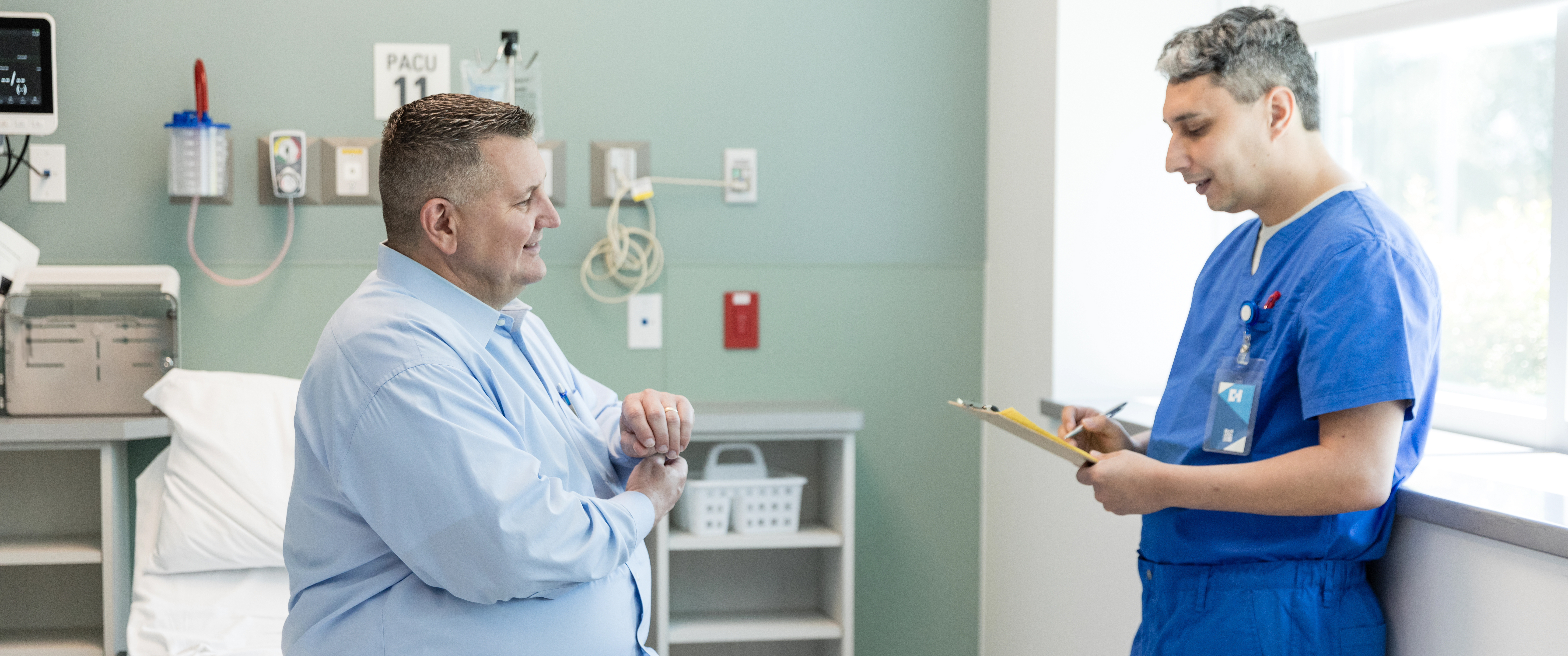 Man who is overweight talking to nurse