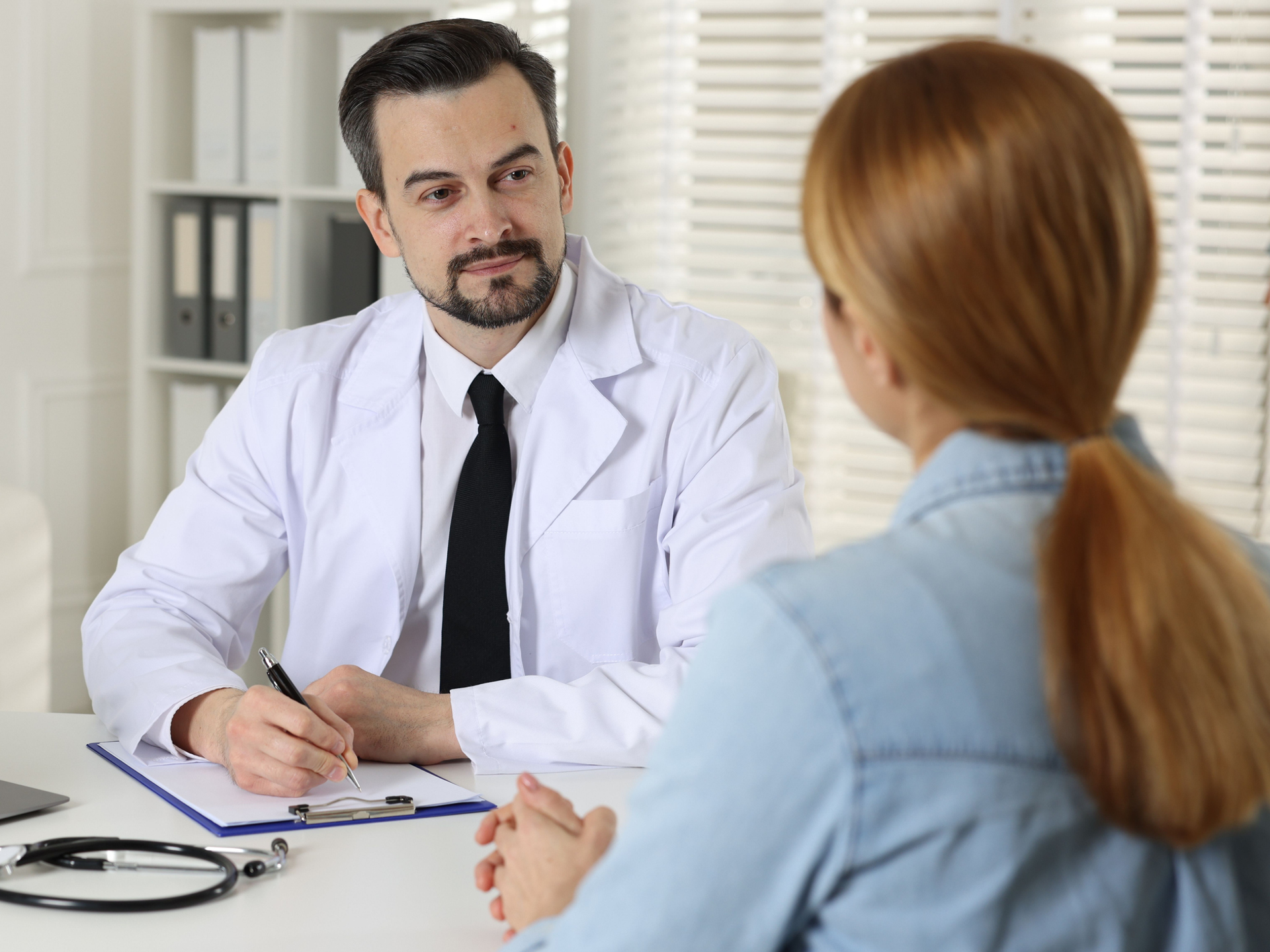 Patient and doctor discussing pituitary symptoms