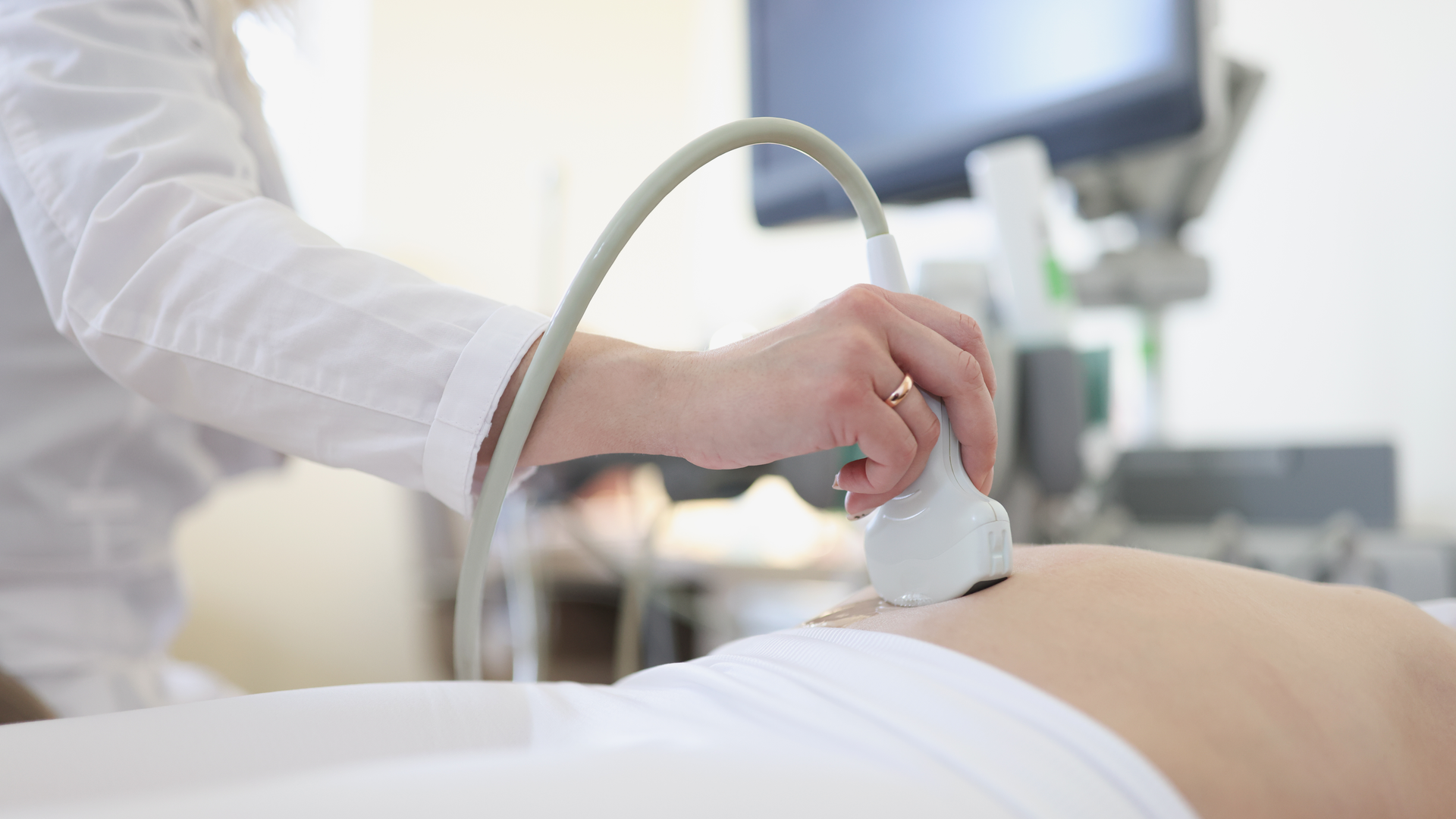 Ultrasound scanner device in hand of professional doctor examining patient
