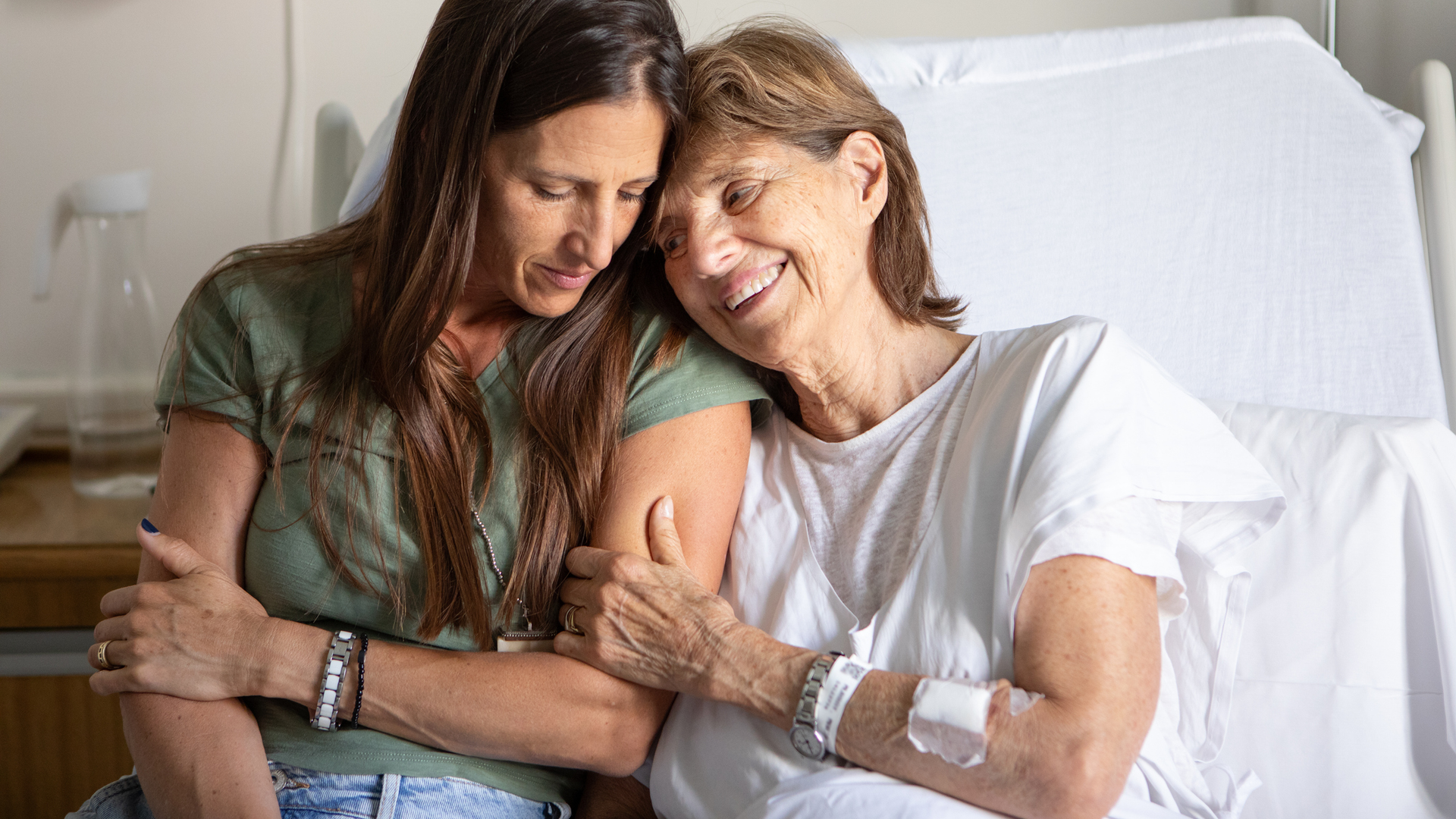 Portrait of an senior woman recovering in a hospital bed after a kidney transplant.