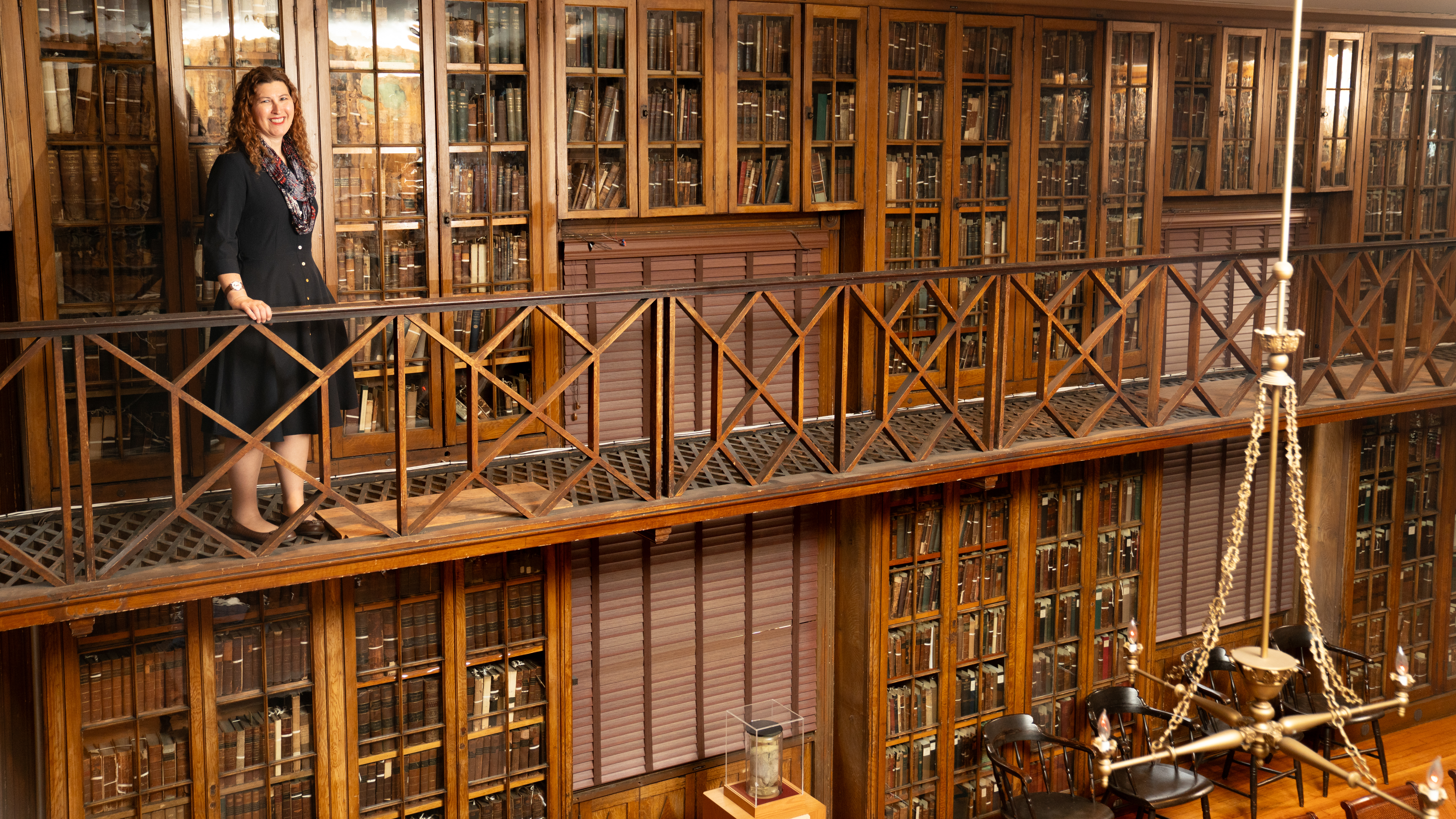 Stacey Peeples standing in the upper level of the Pennsylvania Hospital historic library