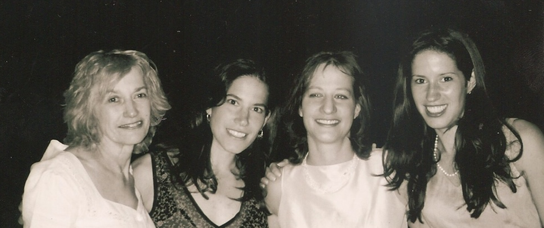 A black and white photo from the 1990s of Pearl Basser with her daughters Shari Potter, Faith Basser, and Mindy Gray