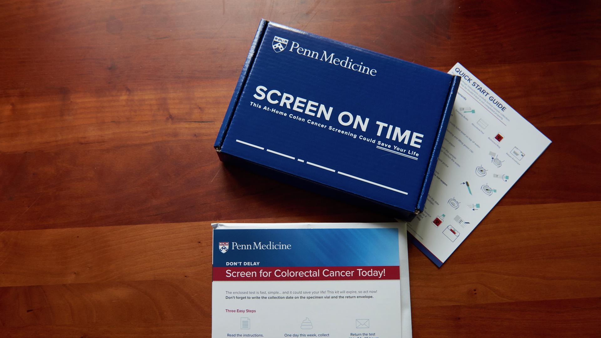 A blue Penn Medicine branded box says "Screen on time: This at-home colon cancer screening could save your life."