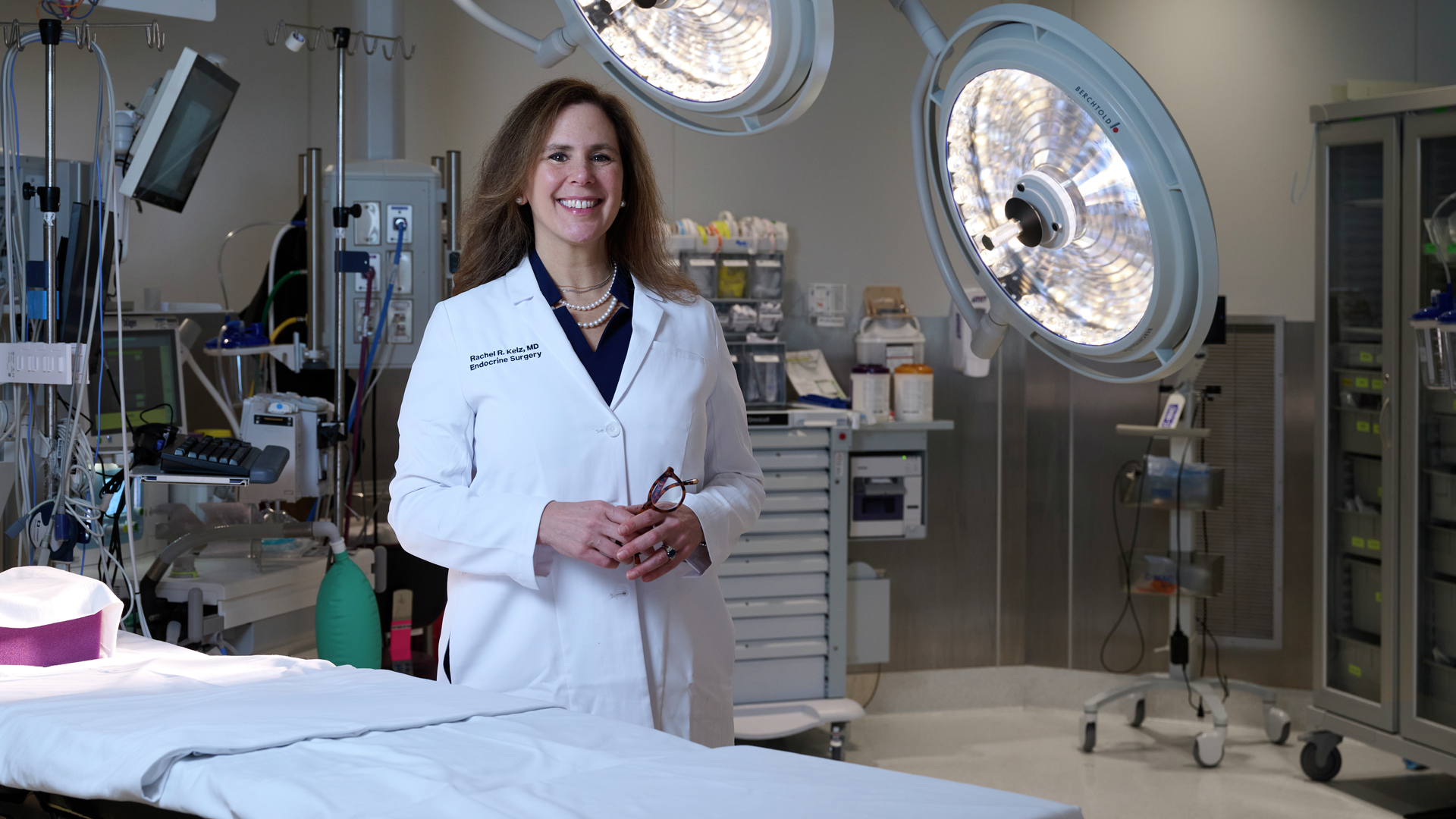 Rachel Kelz, MD, standing in an operating room in a white coat 