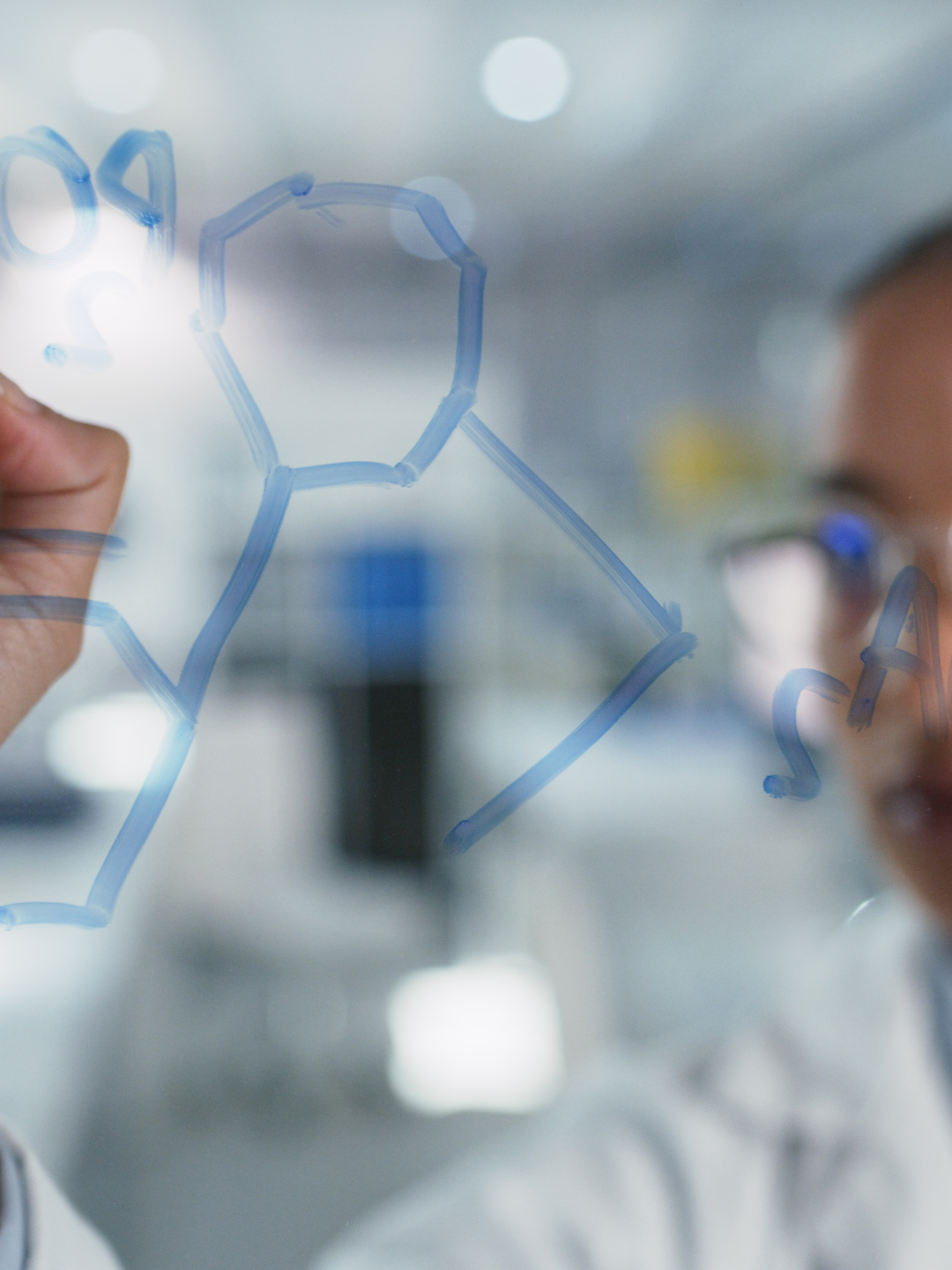 Scientist solves equations on a glass screen in a laboratory