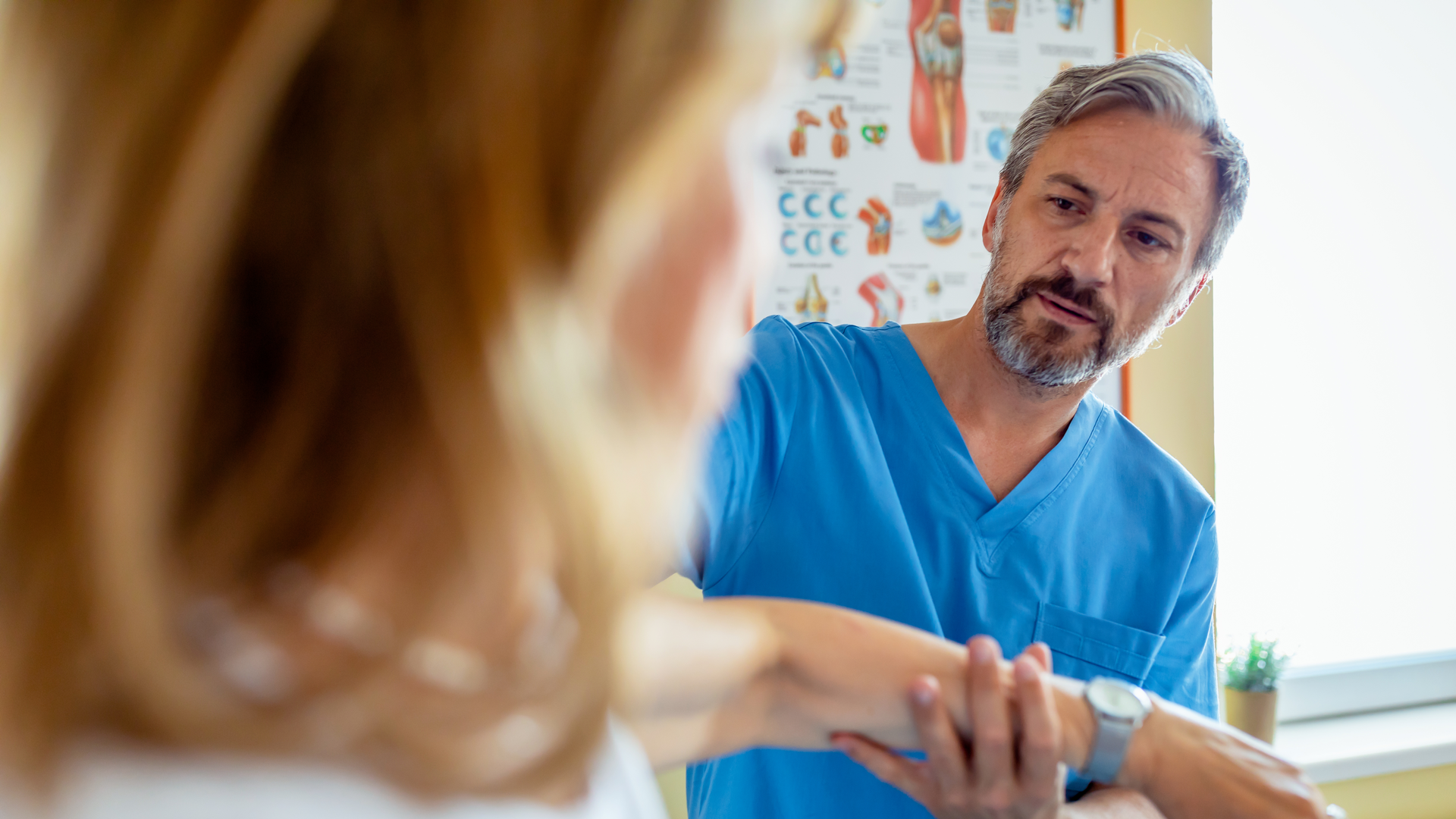 Doctor helping woman with arm injury rehab.jpg