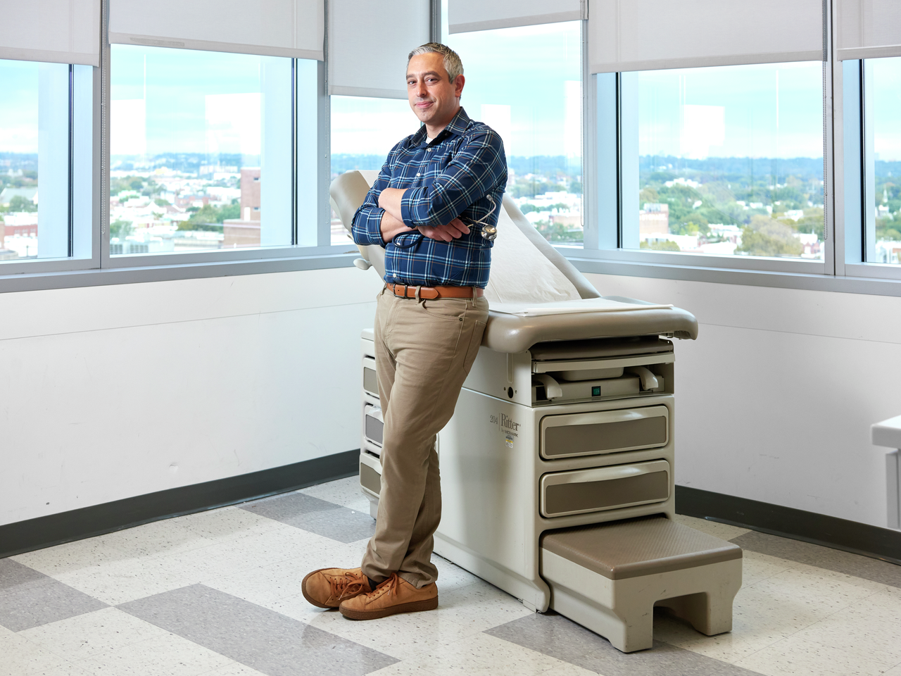 Mario DeMarco, MD, standing in a medical exam room