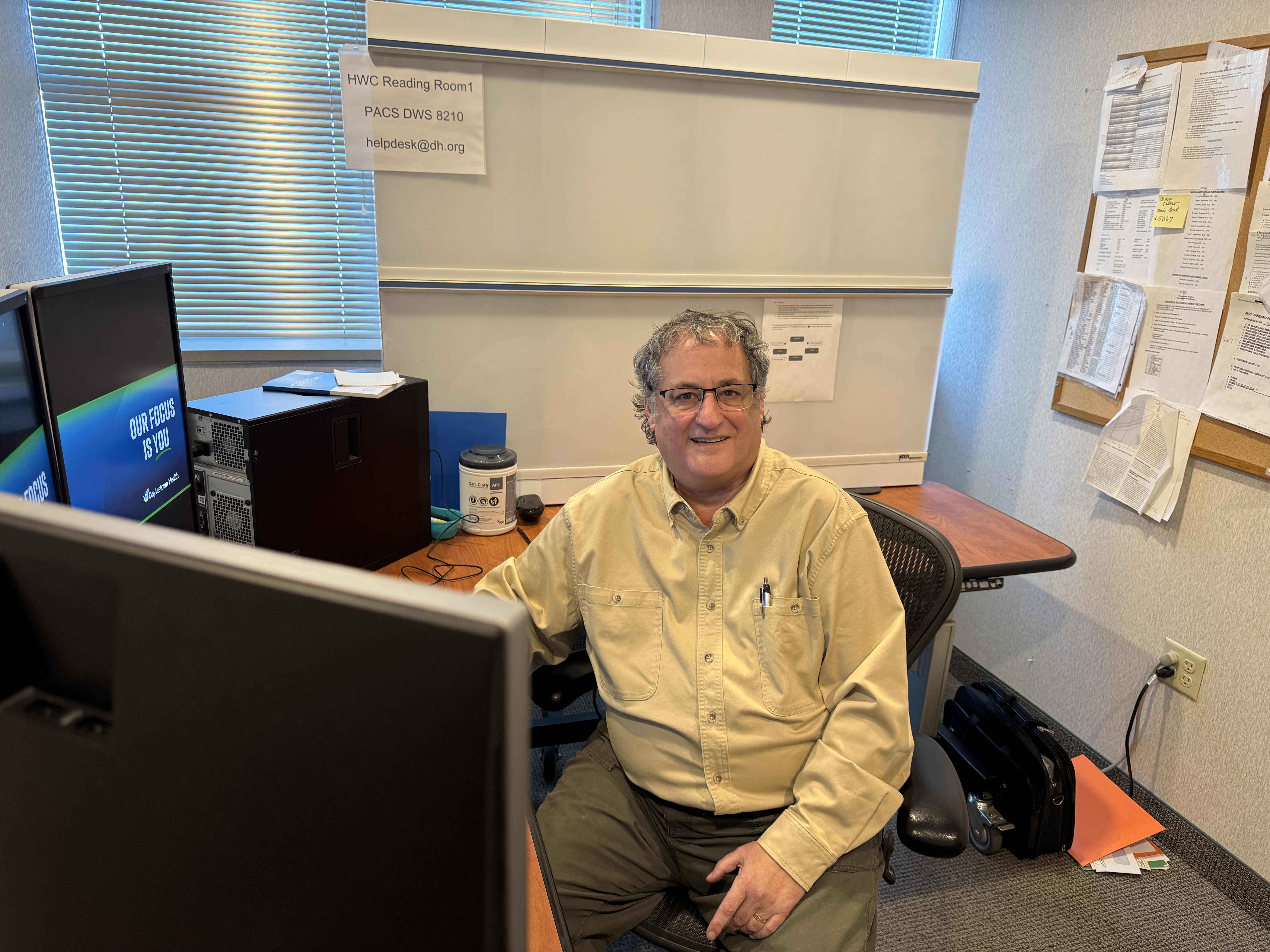 Mark Silidker sits at a desk