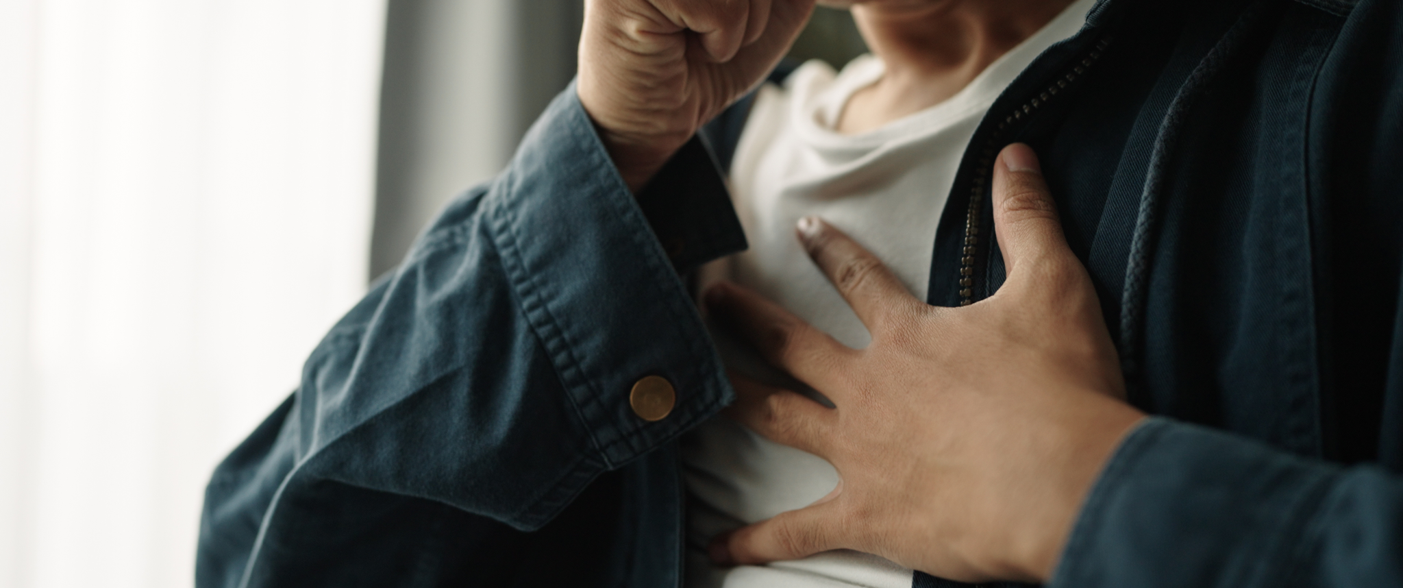 Young man coughing, suffering from chest pain from chronic disease