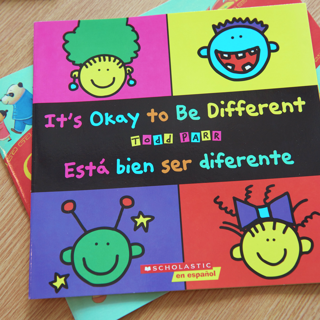 A book cover with the title in both English and Spanish, "It's okay to be different"
