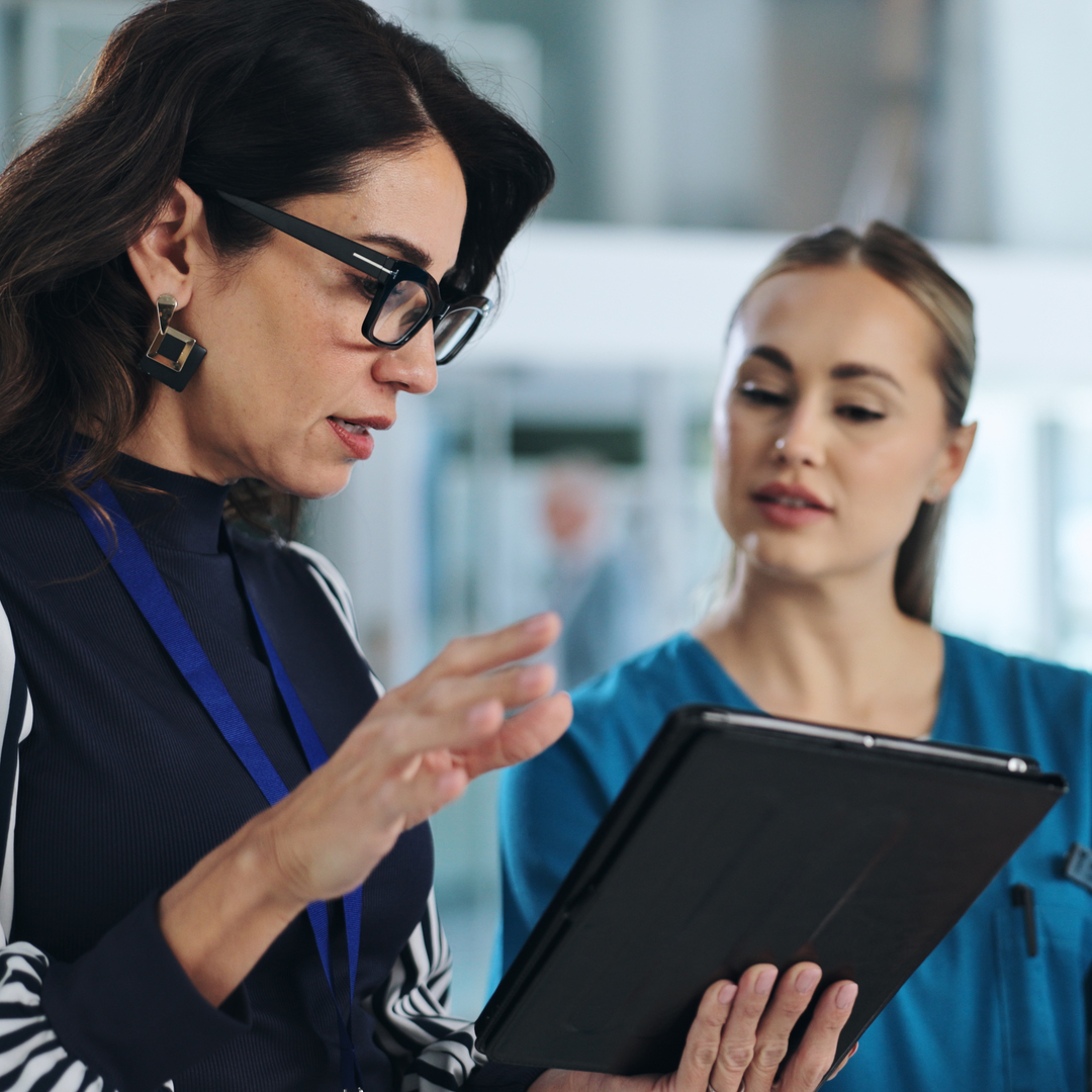 Medical team, tablet and meeting in clinic for advice, innovation and feedback with patient report in a different language. 