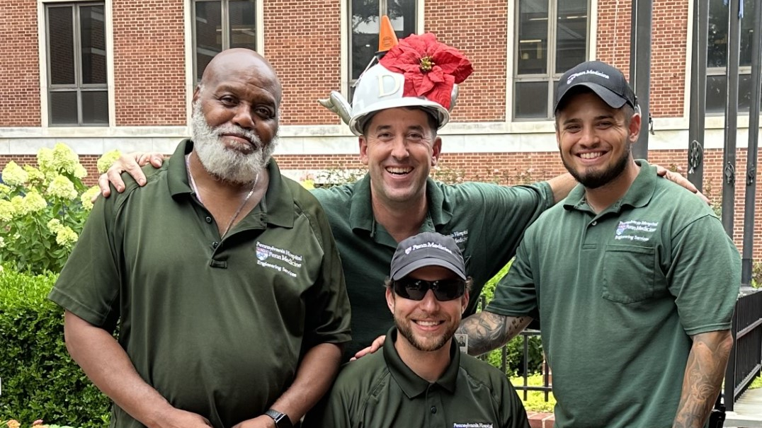 Blake Sieminski, holding the Captain Grounds trophy, sits with Earl Johnson, Dan Bangert, and Nick Sambucett