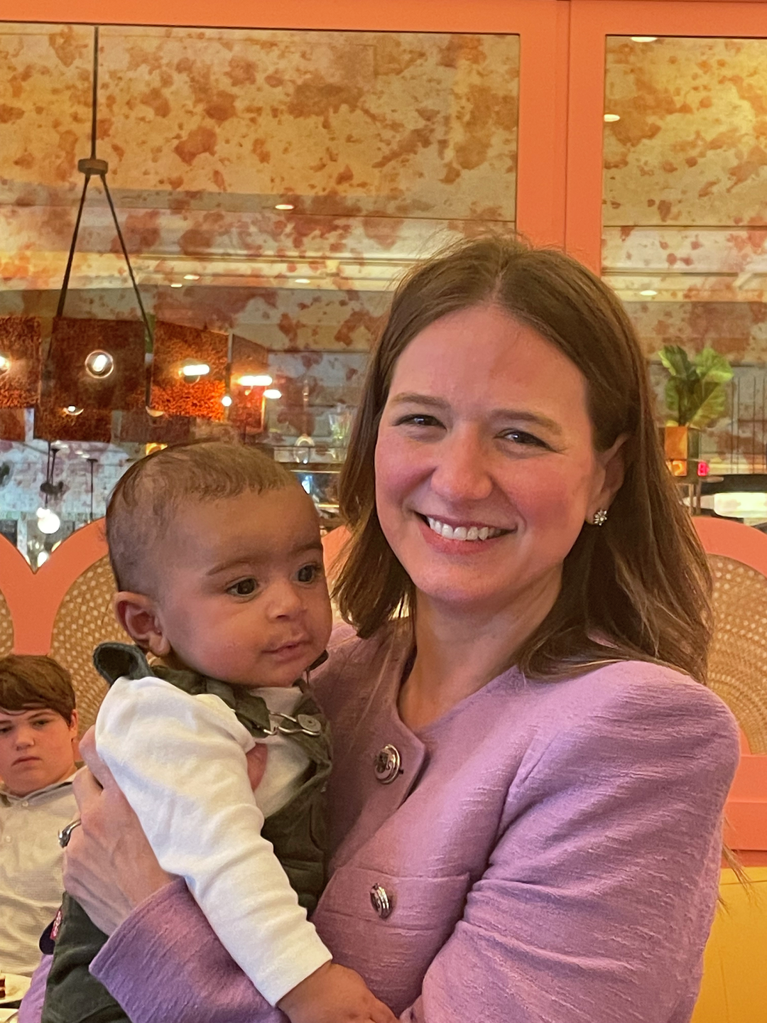 Kate O'Neill, MD, holds a baby born via uterus transplant