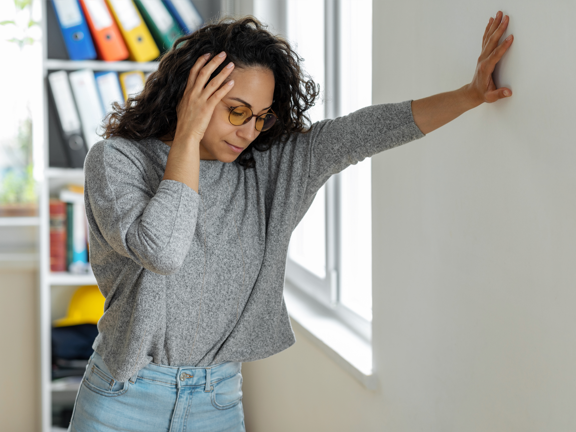 Woman suffering from dizziness with difficulty standing up