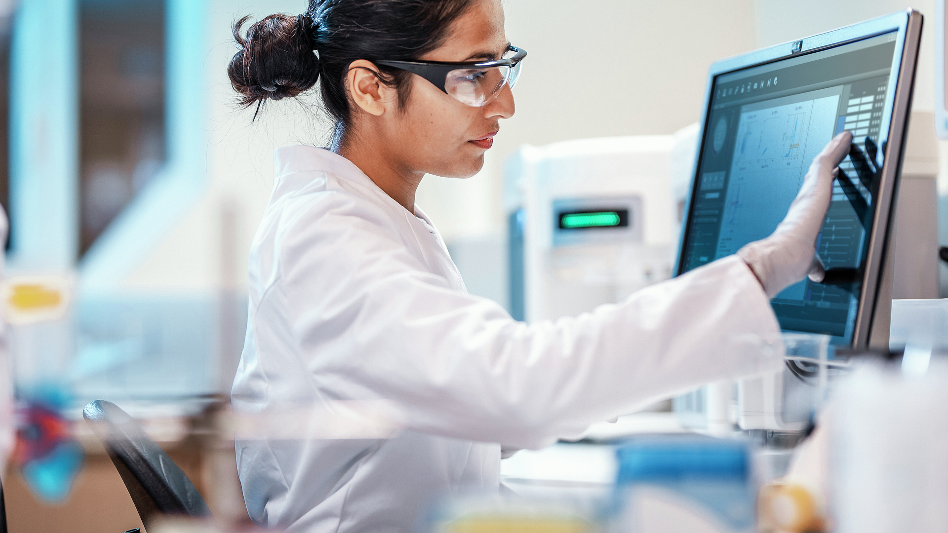 Female scientist working in lab, using computer