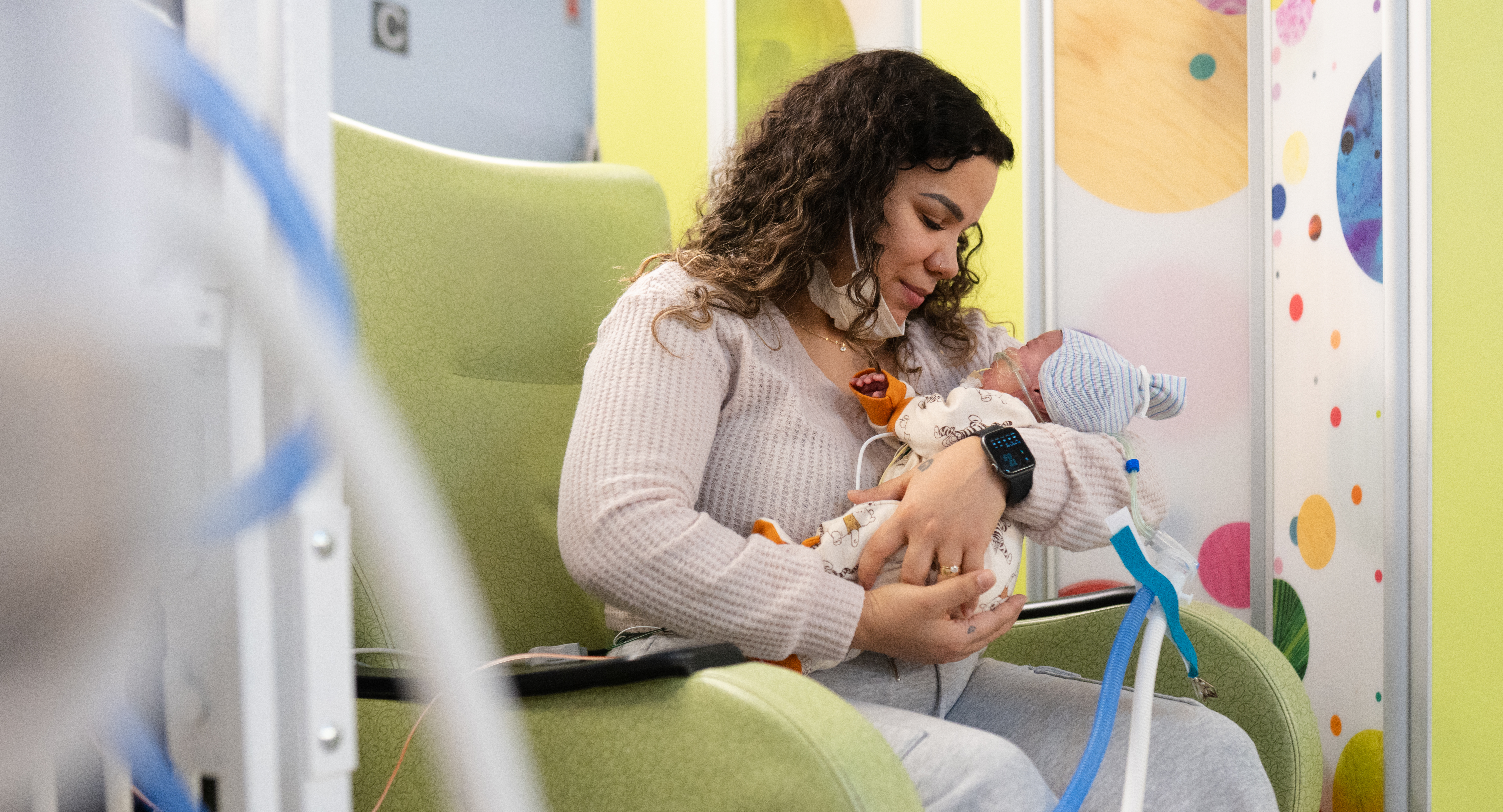 Pamela Collins holding her baby, John, who is wearing the Sonura Beanie.