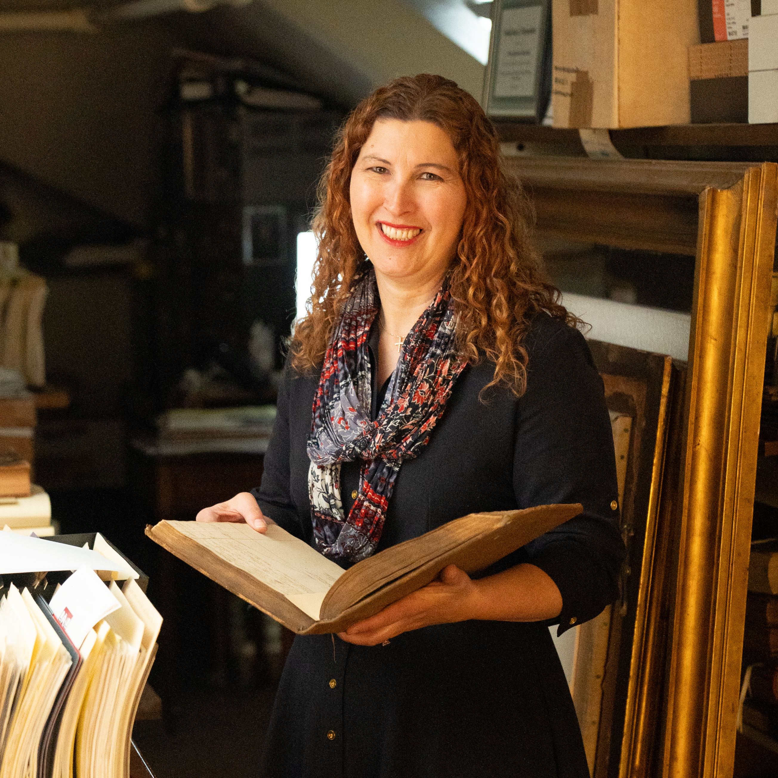 Stacey Peeples in her office, holding a book