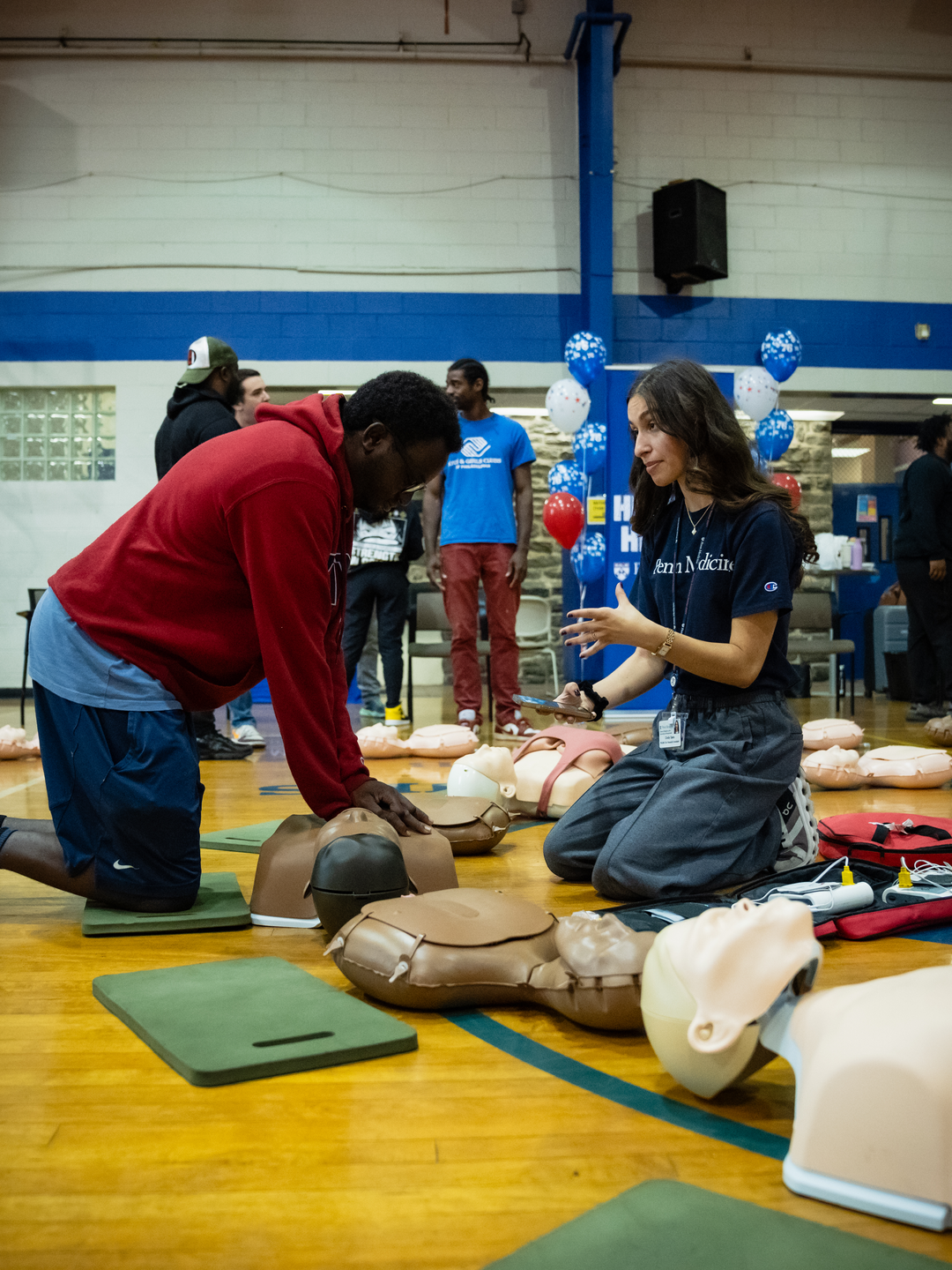 Cindy Sako teaches a man how to perform CPR on a mannikin