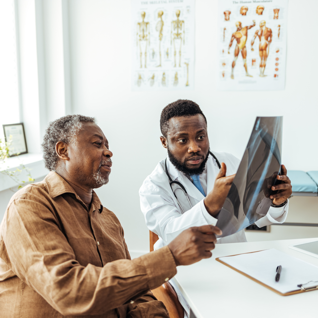 Man and radiologist looking at clear lung x-ray