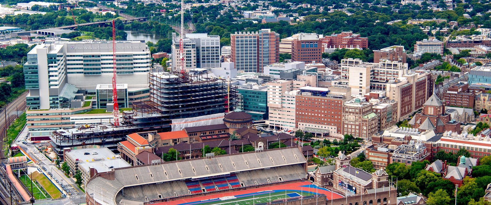 An aerial view of the Penn medical campus in 2018, including HUP, PCAM, Smilow, BRB, CRB, and the active construction of what will become the Clifton Center