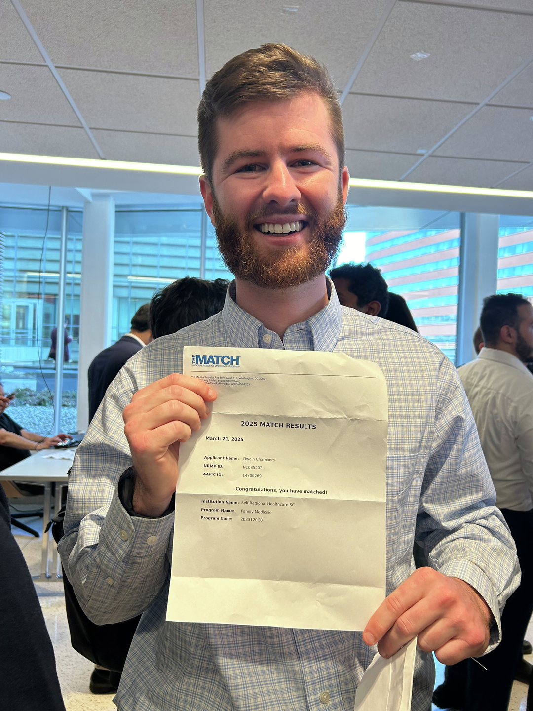 Chip Chambers smiles holding his Match letter