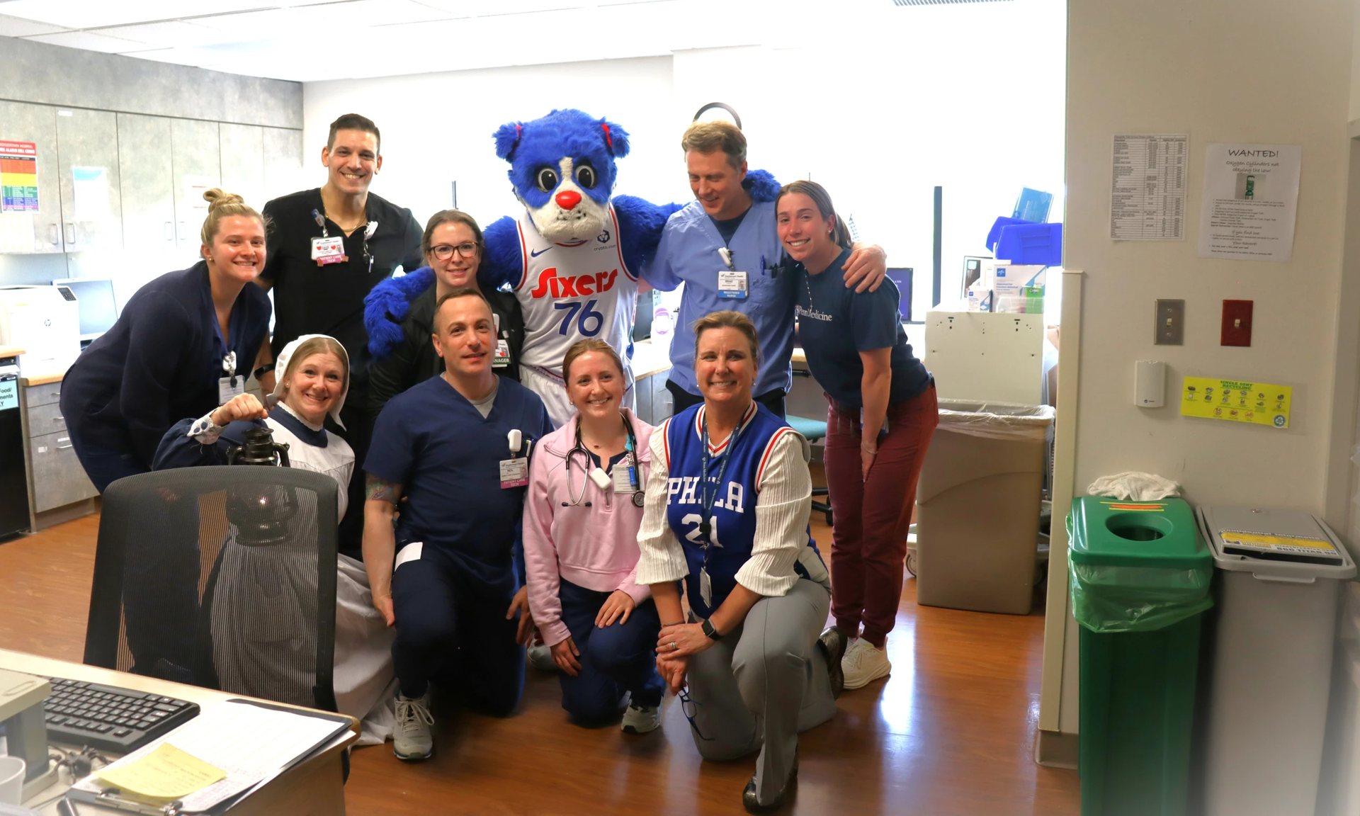 Doylestown Hospital employees smiling with the Sixers mascot Franklin