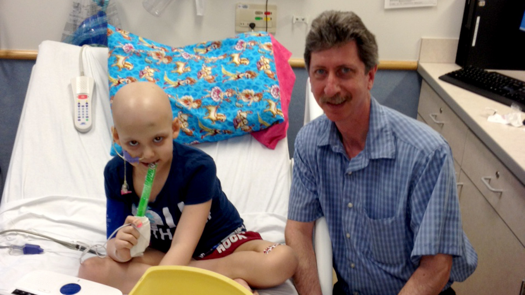 Bruce Levine beside 7-year-old Emily Whitehead in her hospital room