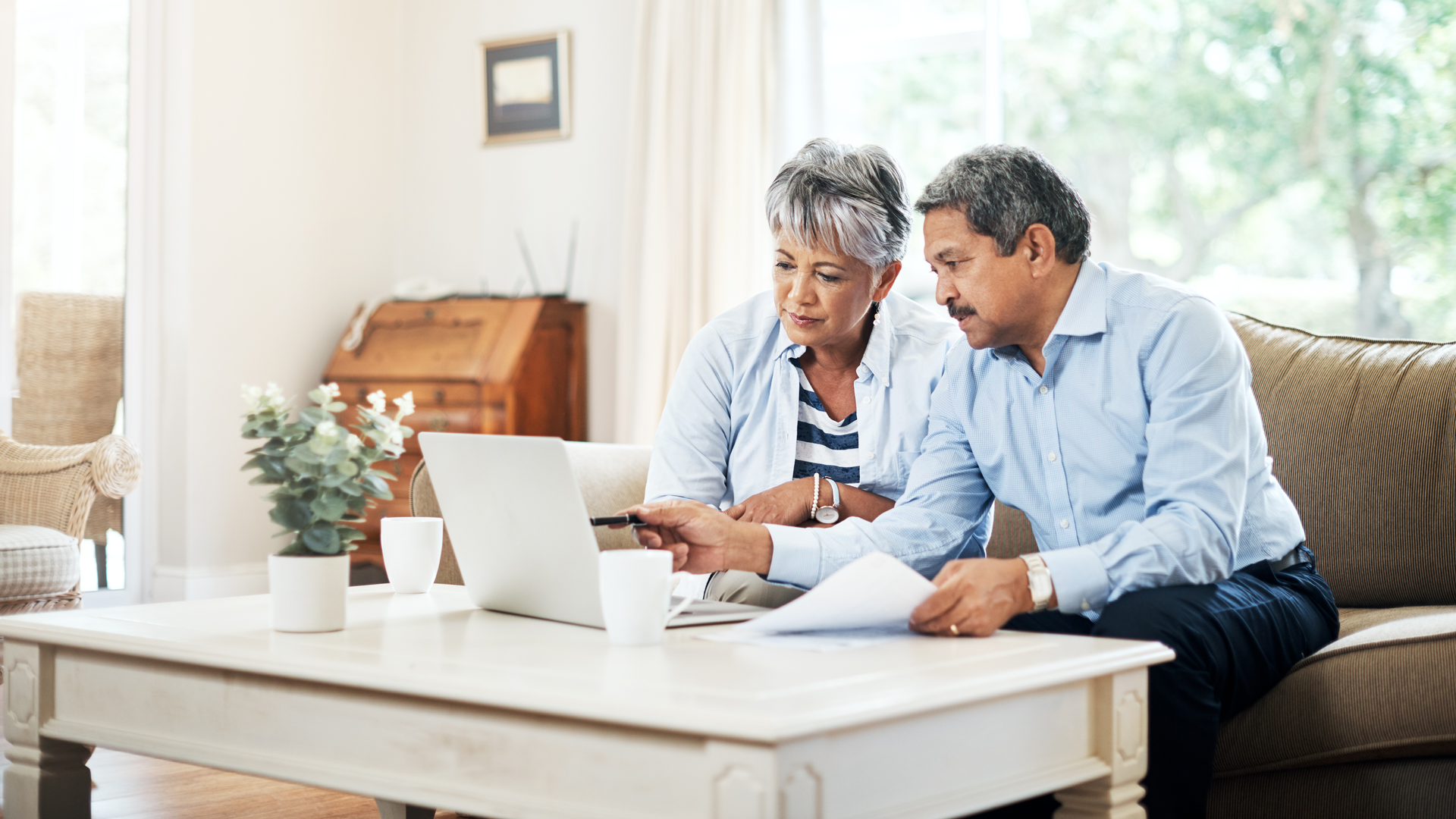 Senior couple using a laptop together at home
