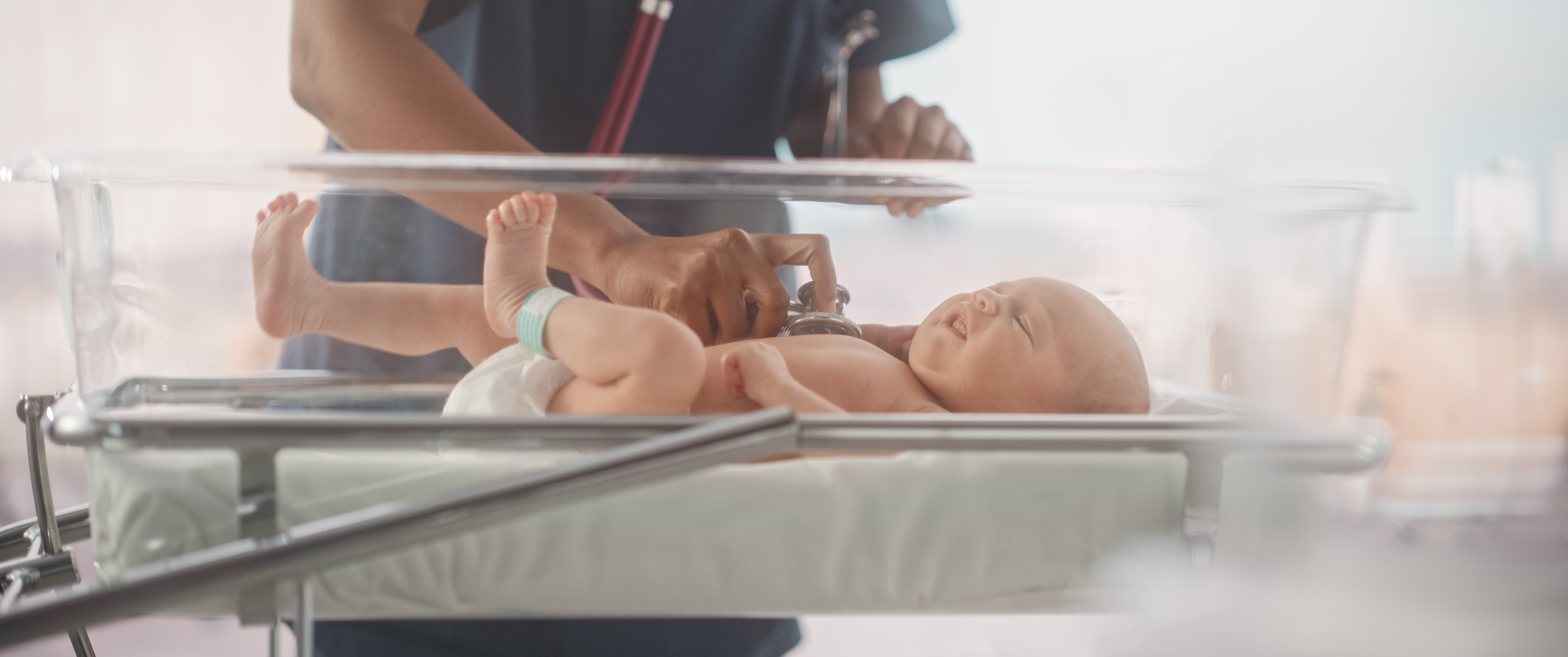 Newborn baby getting examined at hospital