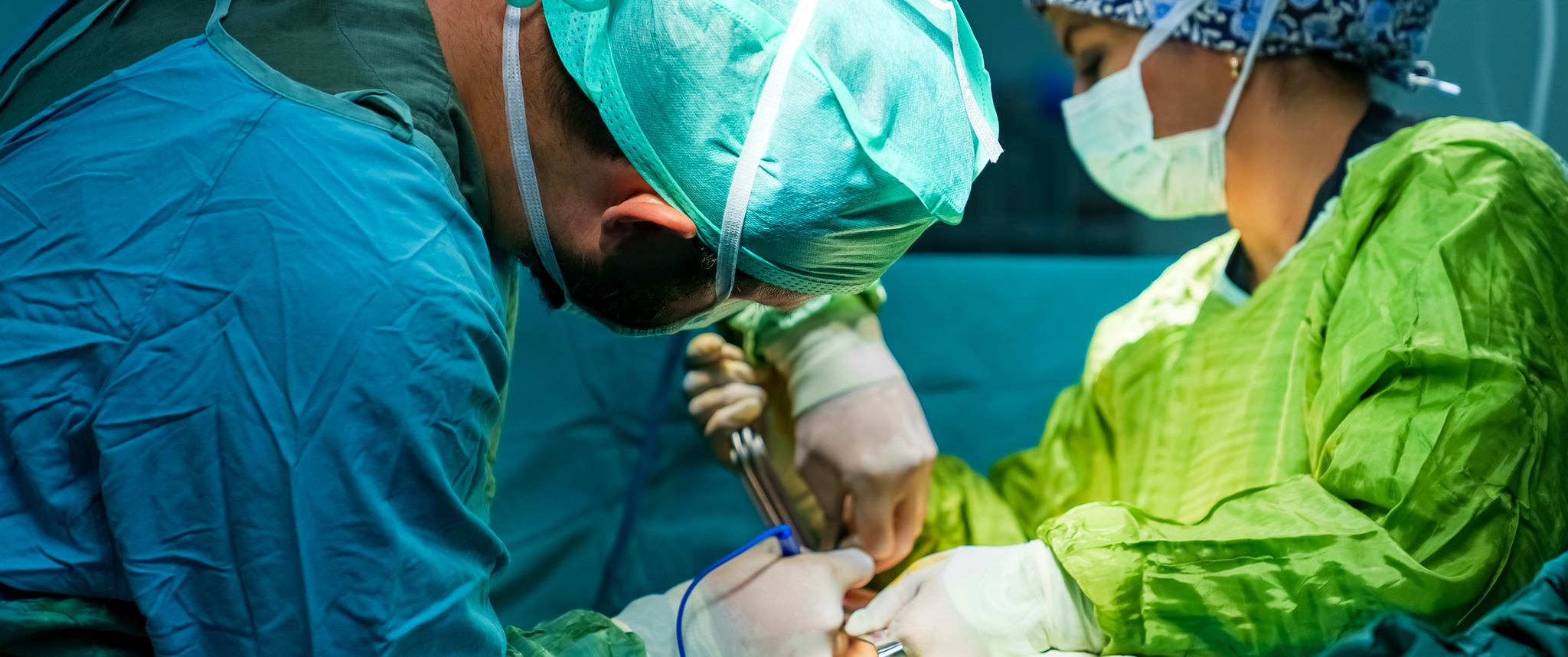 Surgeons perform breast reconstruction surgery in an operating room. 