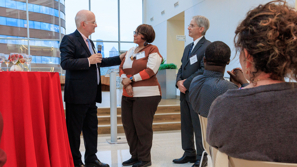 UPHS CEO Kevin Mahoney presents the Community Champion Award to Cheryl Seay as Jonathan Epstein, the interim dean of the Perelman School of Medicine, looks on